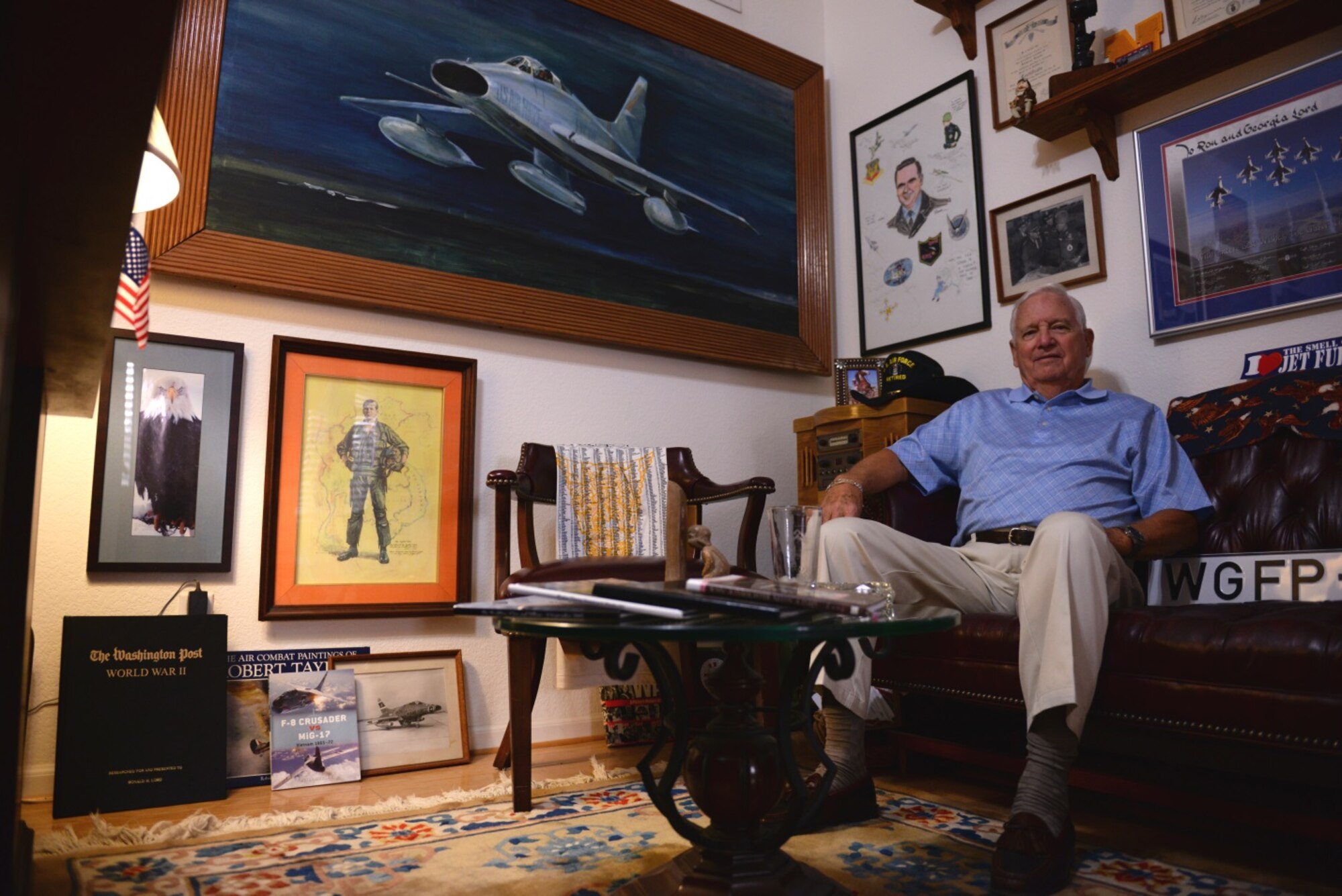 Retired Col. Ronald Lord, former Air Force fighter pilot, sits in a room in his home Oct. 26 where memorabilia of his flying career is displayed. During his Air Force career, Lord flew F-100s, F-8s, and F-4s.