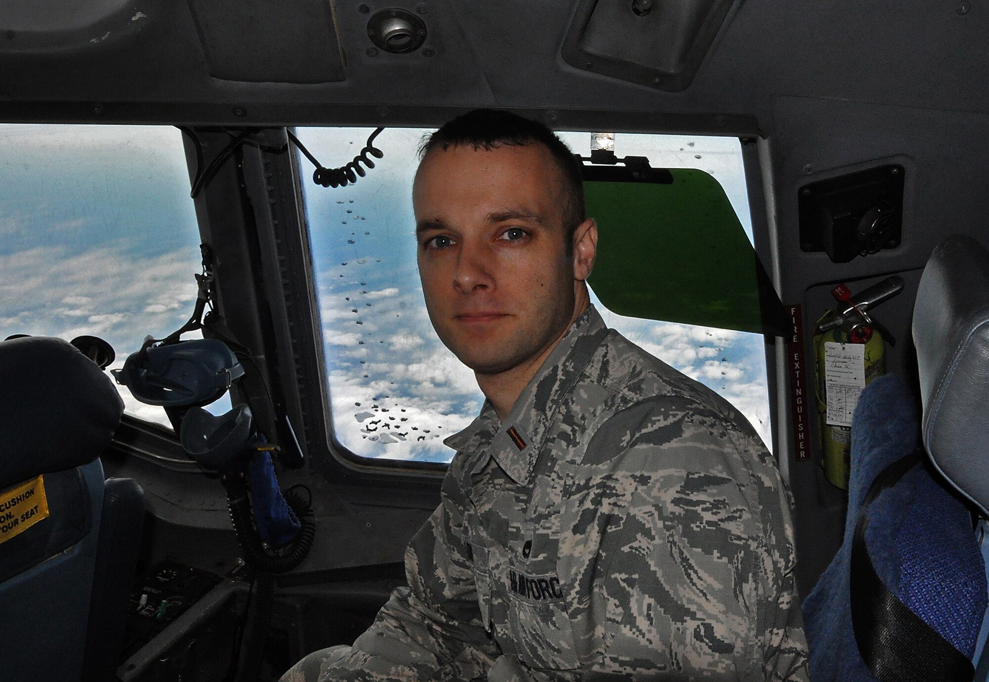 2nd Lt. Chris Long rides behind the copilot in a C-17 Globemaster III, while on his first mission as a public affairs specialist with the 315th Airlift Wing.  THe jet was on a training mission to San Juan, Puerto Rico earlier this month. (U.S. Air Force Photo by Maj. Wayne Capps)