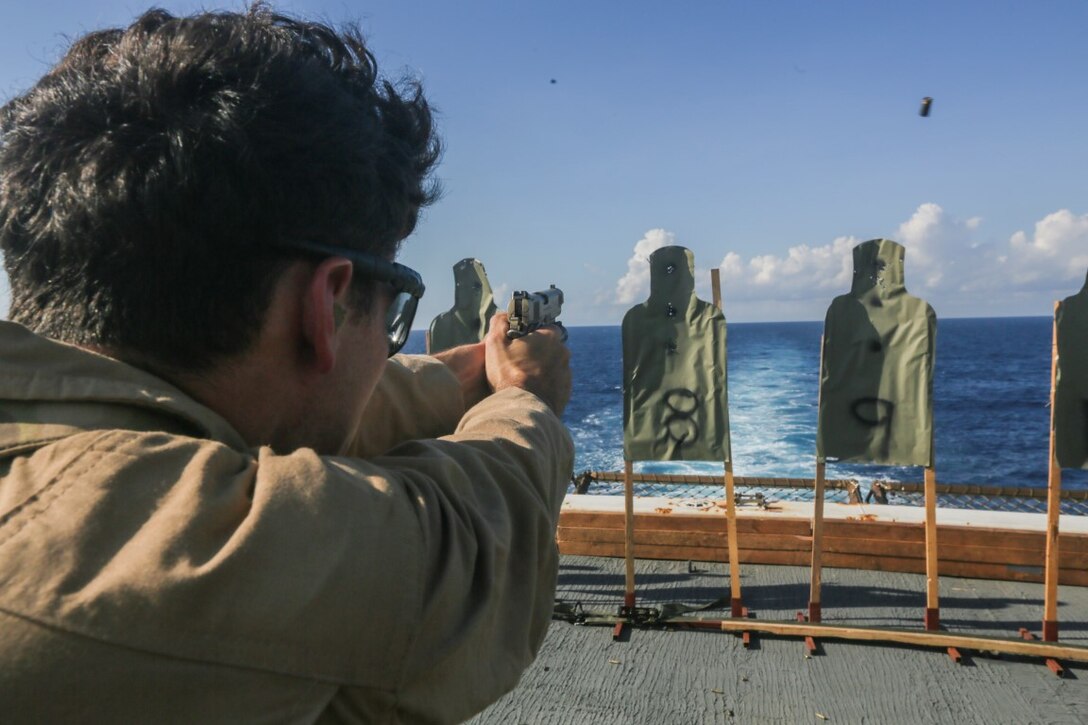SOUTH CHINA SEA (Nov. 14, 2015) U.S. Marine Cpl. Bryan Rodriguez fires an M45 1911 A1 pistol during a deck shoot aboard the USS Anchorage (LPD 23). Rodriguez is a point man with the 15th Marine Expeditionary Unit’s Force Reconnaissance Detachment. The 15th MEU is currently deployed in the Indo-Asia-Pacific region to promote regional stability and security in the U.S. 7th Fleet area of operations. (U.S. Marine Corps photo by Sgt. Jamean Berry/Released)