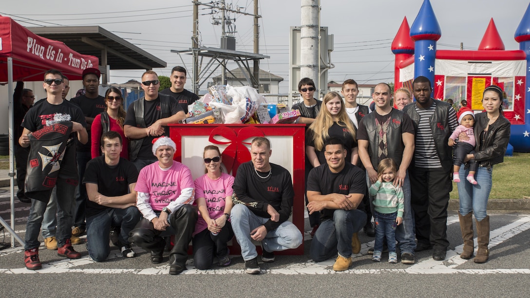 Members of the Endangered Species Motorcycle Club pose by the gift box during the third-annual Toy Drive and Motorcycle Rally at the Marine Thrift shop Nov. 22, 2015, at Marine Corps Air Station Iwakuni, Japan.  Japanese motorcycle clubs, riders from the air station and station residents attended the event to donate toys for Japanese orphans and to participate in contests from best decorated bike to furthest traveled. (U.S. Marine Corps photo by Cpl. Nicole Zurbrugg/Released)