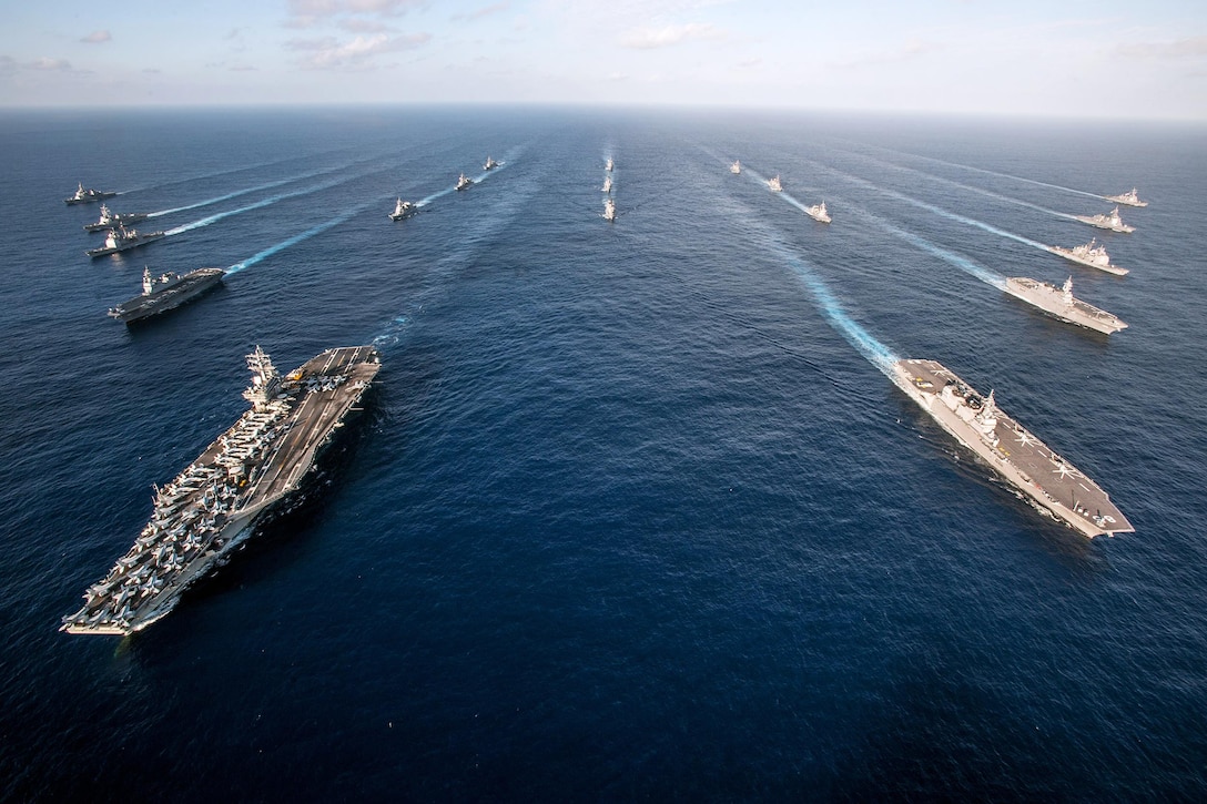 The USS Ronald Reagan Carrier Strike Group steams in formation with Japan Maritime Self-Defense Force ships during a photo exercise in the Pacific Ocean, Nov. 23, 2015. The ships were participating in an annual training exercise aimed at increasing interoperability between Japanese and American forces. U.S. Navy photo by Petty Officer 3rd Class Nathan Burke
