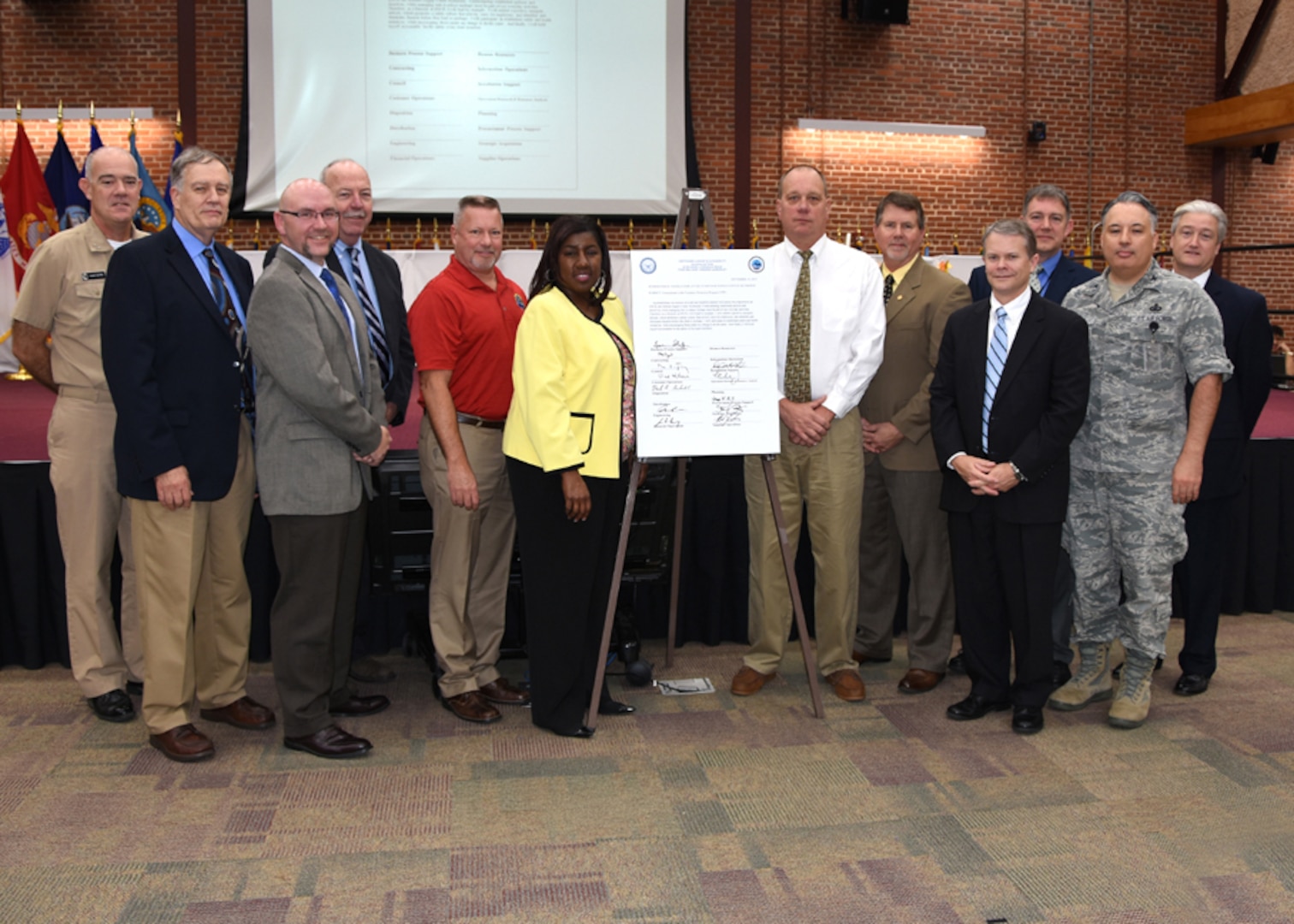 Defense Supply Center Richmond, Virginia, senior leaders pose for a photo after signing the Voluntary Protection Program (VPP) commitment letter during the DSCR, Virginia Safety Stand Down Day program at the Lotts Conference Center, Nov. 19, 2015.