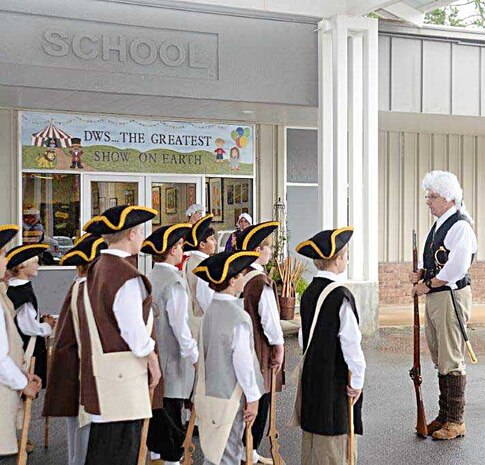 Kent Morrison, executive director, Marine Corps Logistics Base Albany, spends part of Nov. 19 helping fifth grade students at Deerfield-Windsor’s Lower School, Albany, Ga., learn about the American Revolution.  