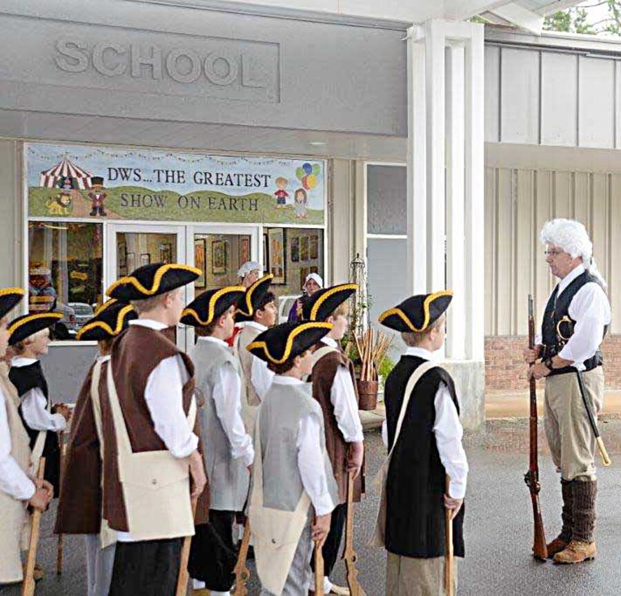 Kent Morrison, executive director, Marine Corps Logistics Base Albany, spends part of Nov. 19 helping fifth grade students at Deerfield-Windsor’s Lower School, Albany, Ga., learn about the American Revolution.  