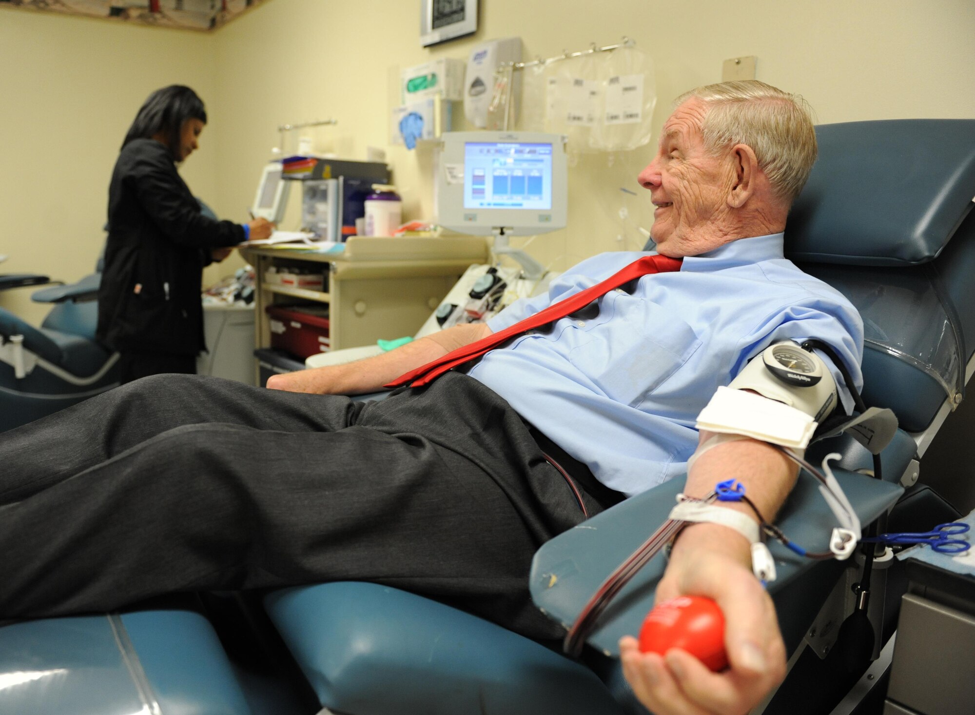 Al Whitney, Platelets Across America founder/consultant, donates platelets as Stephanie Stringfield, 81st Diagnostic and Therapeutics Squadron clinical laboratory technician, updates his chart at the Medical Center Nov. 23, 2015, Keesler Air Force Base, Miss.  Whitney has made over 760 donations in his life time.  He has also donated platelets in all 50 states over the last five years. (U.S. Air Force photo by Kemberly Groue)