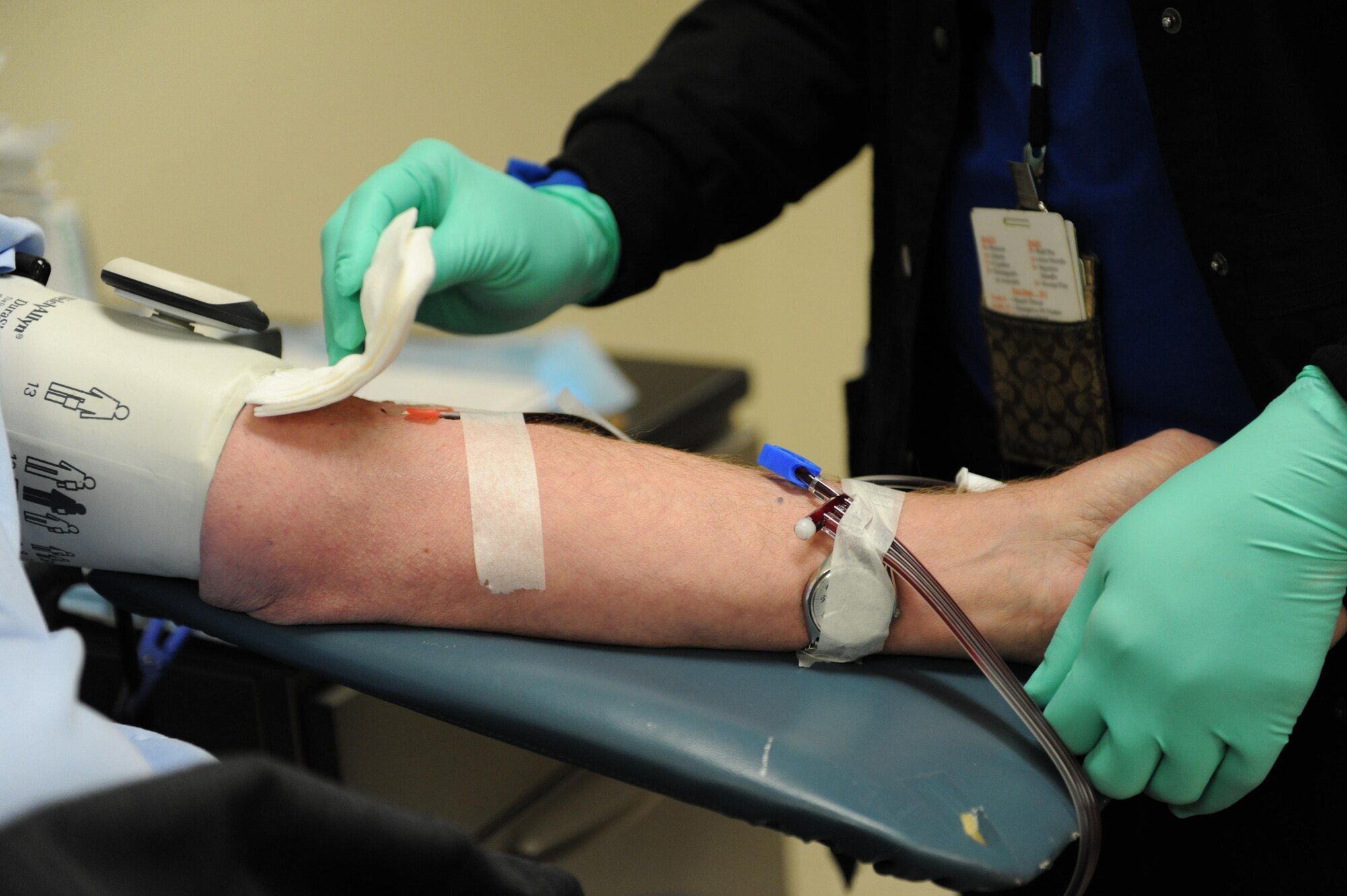 Stephanie Stringfield, 81st Diagnostic and Therapeutics Squadron clinical laboratory technician, checks the port in the arm of Al Whitney, Platelets Across America founder/consultant, as Whitney donates platelets at the Medical Center Nov. 23, 2015, Keesler Air Force Base, Miss.  Whitney has made over 760 donations in his life time.  He has also donated platelets in all 50 states over the last five years. (U.S. Air Force photo by Kemberly Groue)