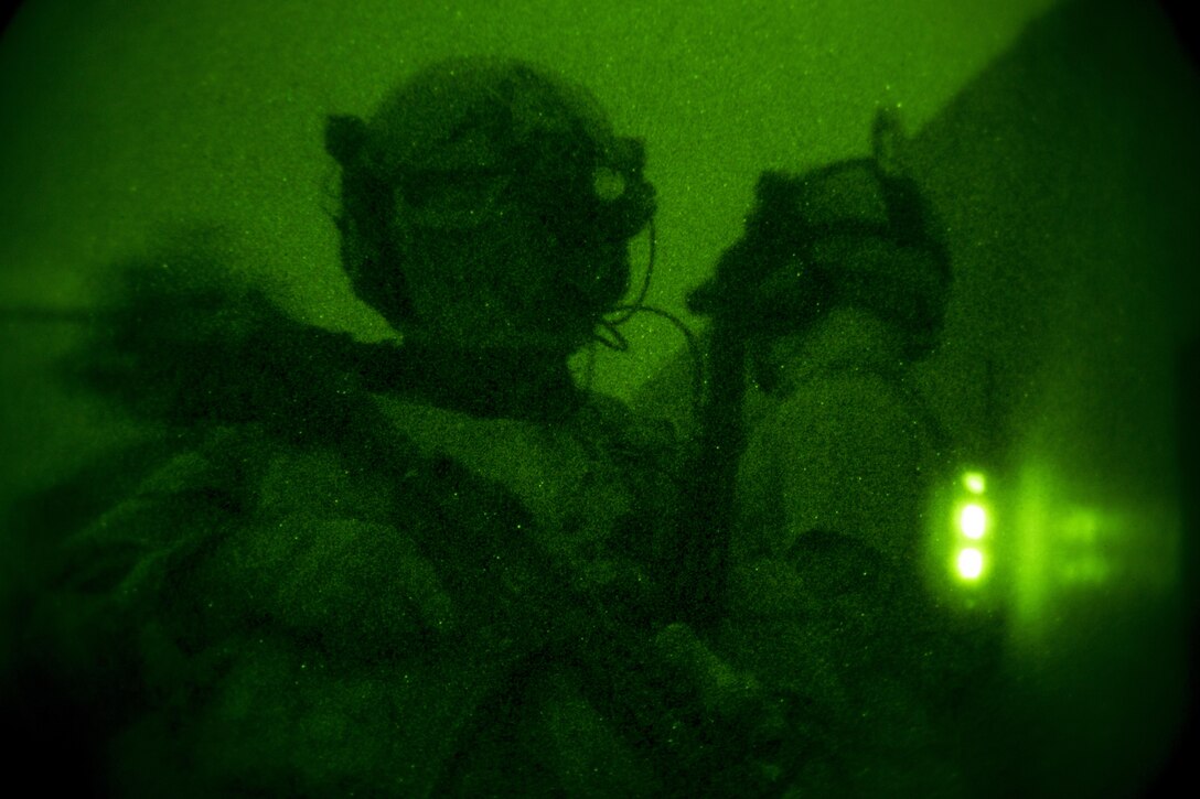 A Marine Raider with Marine Special Operations Company Charlie, 1st Marine Raider Battalion, U.S. Marine Corps Forces, Special Operations Command, provides security to his team conducting a notional direct-action night raid, during a Company Collective Exercise, Oct. 17, 2015, in Florence, Ariz.