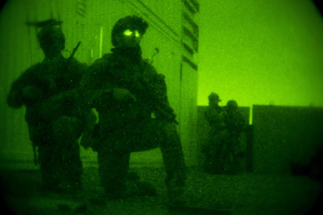 Marine Raiders with Marine Special Operations Company Charlie, 1st Marine Raider Battalion, U.S. Marine Corps Forces, Special Operations Command, set up a cordon around the perimeter of a building, while conducting a notional direct-action night raid, during a Company Collective Exercise, Oct. 17, 2015, in Florence, Ariz.