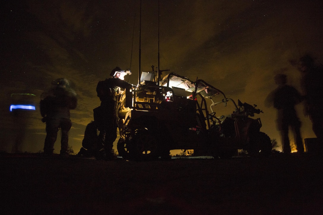Marine Raiders with Marine Special Operations Company Charlie, 1st Marine Raider Battalion, U.S. Marine Corps Forces, Special Operations Command, process intelligence and set up a visual tele-communication feed after a notional direct-action night raid, a part of a Company Collective Exercise, Oct. 20, 2015, along the Arizona-California state line.
