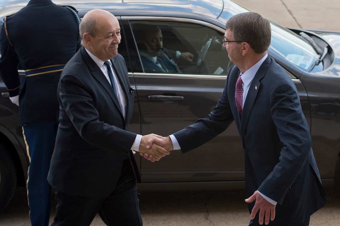 U.S. Defense Secretary Ash Carter shakes hands with French Defense Minister Jean-Yves Le Drian upon welcoming him to the Pentagon, Nov. 24, 2015. DoD photo by Air Force Senior Master Sgt. Adrian Cadiz