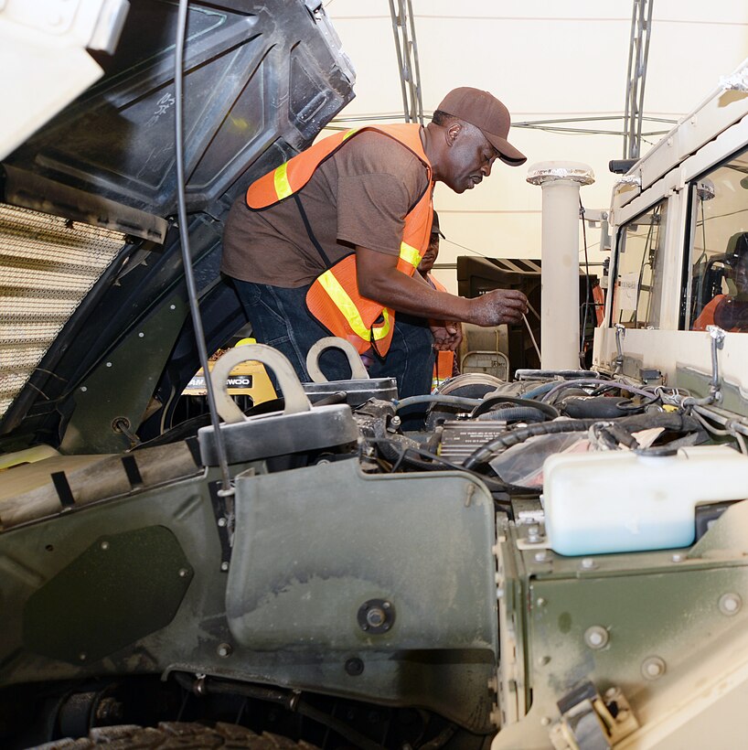 Melvin Williams, mechanic, Marine Corps Logistics Command, checks the fluid level on a vehicle recently while performing the level A preservation process aboard Marine Corps Logistics Base Albany. This is one step in an extensive process to help prevent deterioration of vehicles stored outside.
