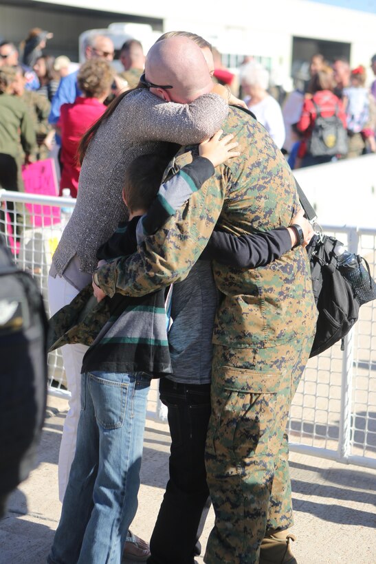 A Marine with Marine Heavy Helicopter Squadron (HMH) 462 hugs his family aboard Marine Corps Air Station Miramar, Calif., Nov. 20. The Marines were returning from a seven-month deployment. (U.S. Marines photo by Lance Cpl. Kimberlyn Adams/Released)