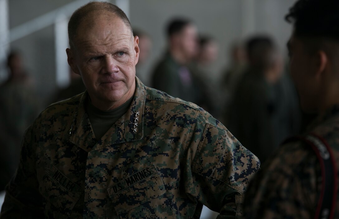The 37th Commandant of the Marine Corps, Gen. Robert B. Neller, speaks with Cpl. Isaac Ibarra during a Nov. 23 visit to Marine Corps Air Station Futenma. The CMC and Sgt. Maj. of the Marine Corps Ronald L. Green visited III Marine Expeditionary Force, the “tip of the spear,” in the Asia-Pacific region by traveling around and speaking with forward deployed Marines across the installations that comprise Marine Corps Base Camp Smedley D. Butler, Okinawa, Japan. The Marine Corps must be maintained as a crisis response force and a force in readiness, to include the ability for Marines to remain forward deployed and ready to fight and win. Ibarra is a combat correspondent with III MEF. 