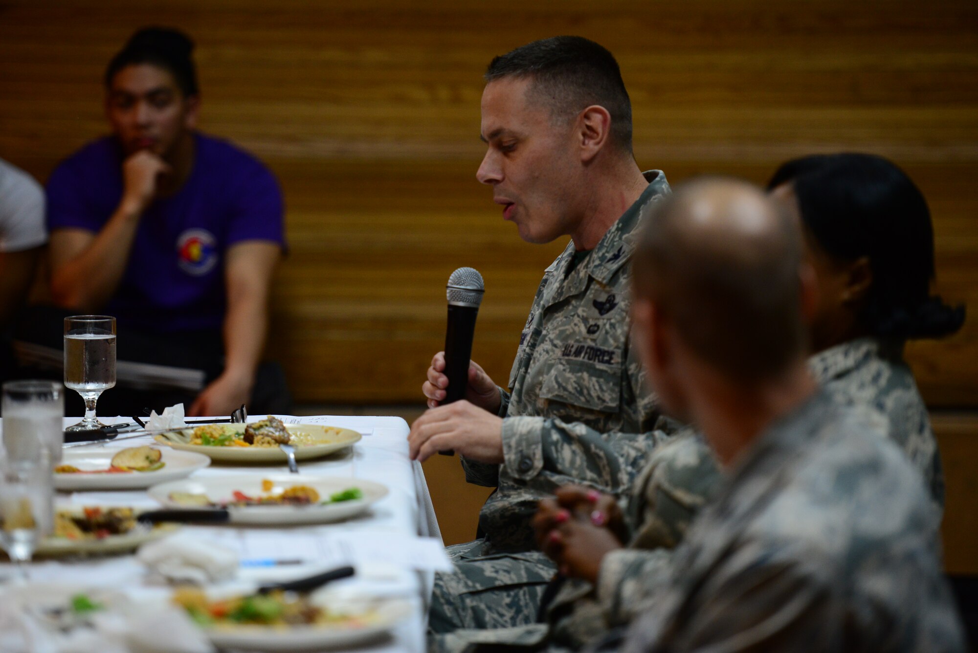 Col. Carl Misner, 51st Mission Support Group commander and taste-testing judge, speaks to the crowd during the food portion of the bi-annual Force Support Squadron Challenge held at Osan Air Base, Republic of Korea, Nov. 20, 2015. FSS Airmen from Kunsan and Osan AB were given one hour to prepare a three-course meal that would be judged on taste and presentation. (U.S. Air Force photo/Staff Sgt. Amber Grimm)