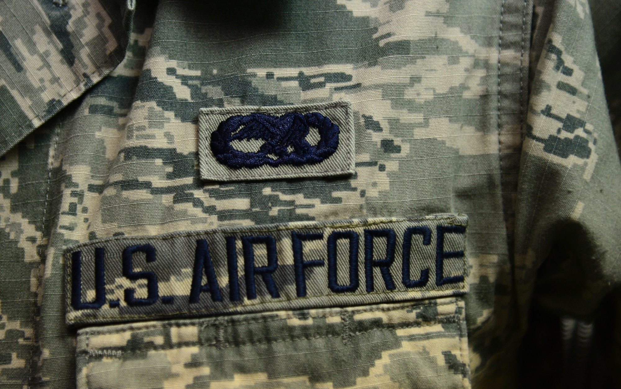 U.S. Air Force Airman 1st Class Summer Seale, a 354th Maintenance Group wing plans, scheduling and documentation apprentice, displays her occupational badge Nov. 23, 2015, at Eielson Air Force Base, Alaska. Seale said serving in the Air Force is important to her because she gets to serve her country. (U.S. Air Force photo by Airman 1st Class Cassandra Whitman/Released)
