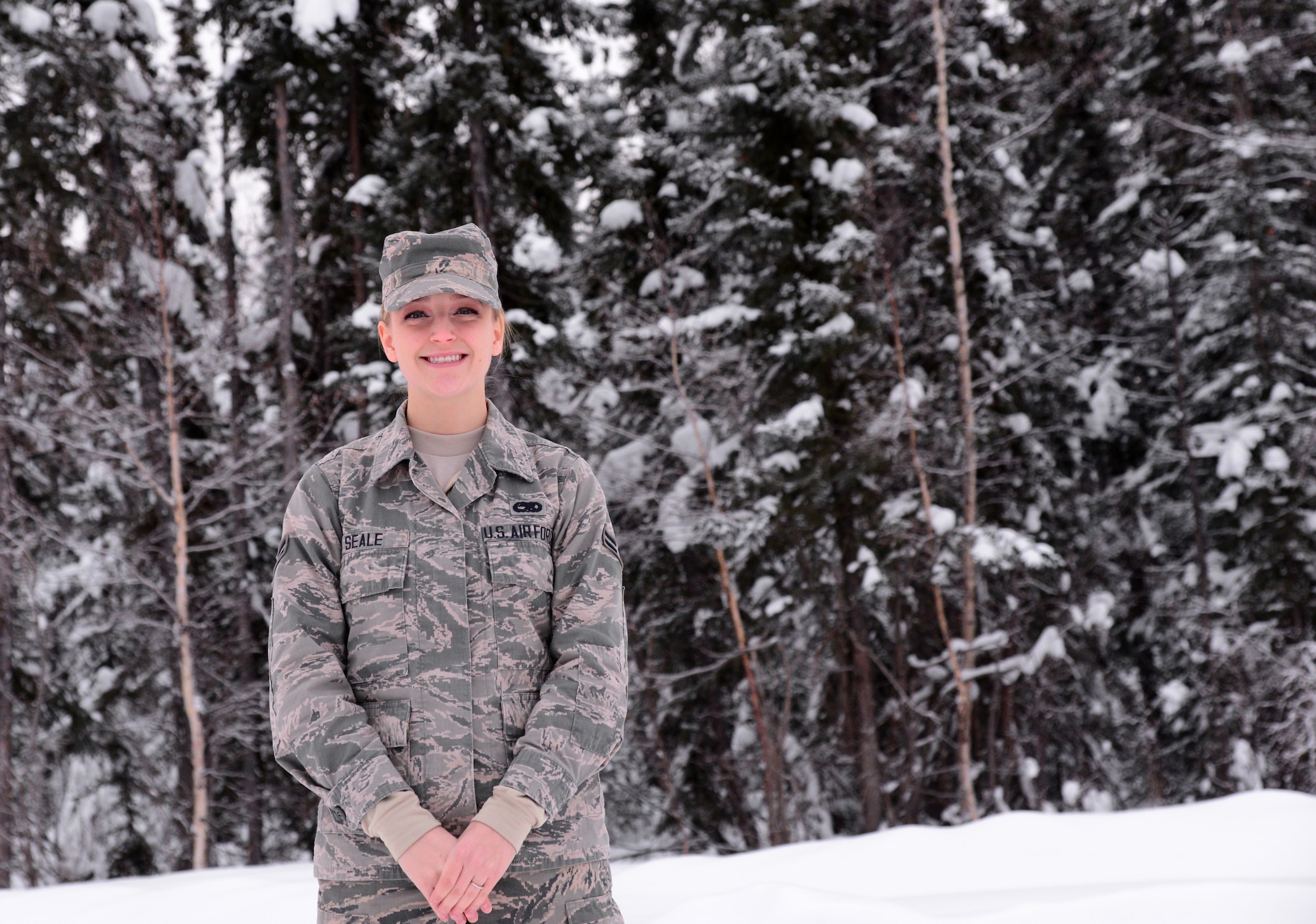 U.S. Air Force Airman 1st Class Summer Seale, a 354th Maintenance Group wing plans, scheduling and documentation apprentice, takes a break in the snow Nov. 23, 2015, at Eielson Air Force Base, Alaska. Seale said her favorite part of living in Alaska is the snow. (U.S. Air Force photo by Airman 1st Class Cassandra Whitman/Released)