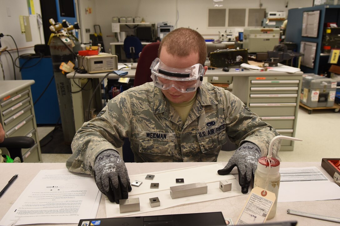 Senior Airman Kasey Weidman, 4th Component Maintenance Squadron test, measurement and diagnostic equipment technician, prepares to calibrate a caliper using gage blocks, Nov. 18, 2015, at Seymour Johnson Air Force Base, North Carolina. The precision measurement equipment lab handles anywhere from 20 to 60 items on a daily basis. (U.S. Air Force photo/Airman Shawna L. Keyes) 