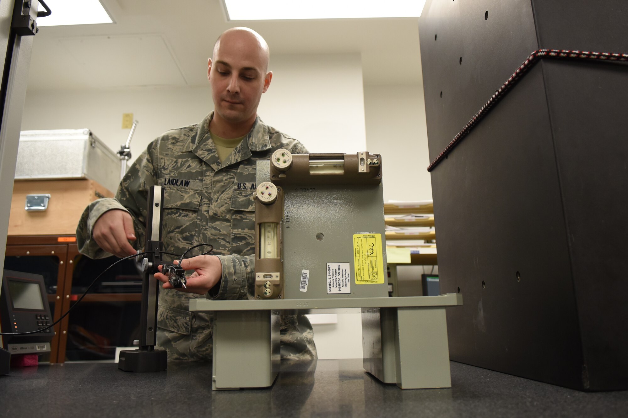 Senior Airman James Laidlaw, 4th Component Maintenance Squadron test, measurement and diagnostic equipment technician, measures height deviations of an aircraft antenna precision mounting adapter, Nov. 18, 2015, at Seymour Johnson Air Force Base, North Carolina. Laidlaw and other members of the precision measurement equipment lab calibrate, troubleshoot, and repair all supported equipment for the base. (U.S. Air Force photo/Airman Shawna L. Keyes)