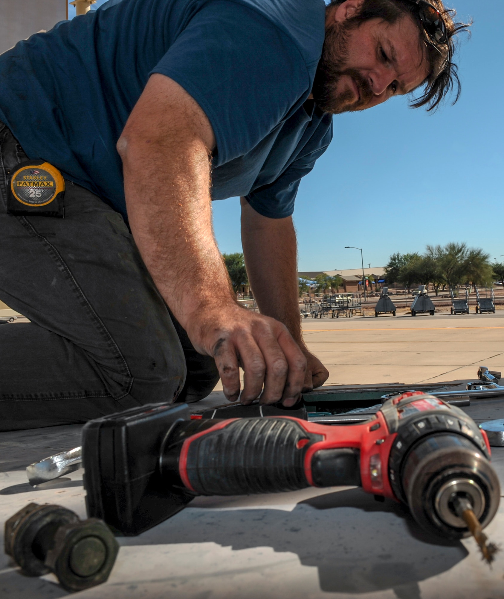 David Williamson, chief project manager, reaches for a drill while working on an F-15A Eagle on the flightline at Davis-Monthan Air Force Base, Ariz., Nov. 18, 2015. Williamson will travel to Joint Base Lewis-McChord, Wash., to complete the project of reassembling the aircraft and putting it on display. The entire project is estimated to take approximately eight months from the planning stage to finish. (U.S. Air Force photo by Airman Basic Nathan H. Barbour/Released)