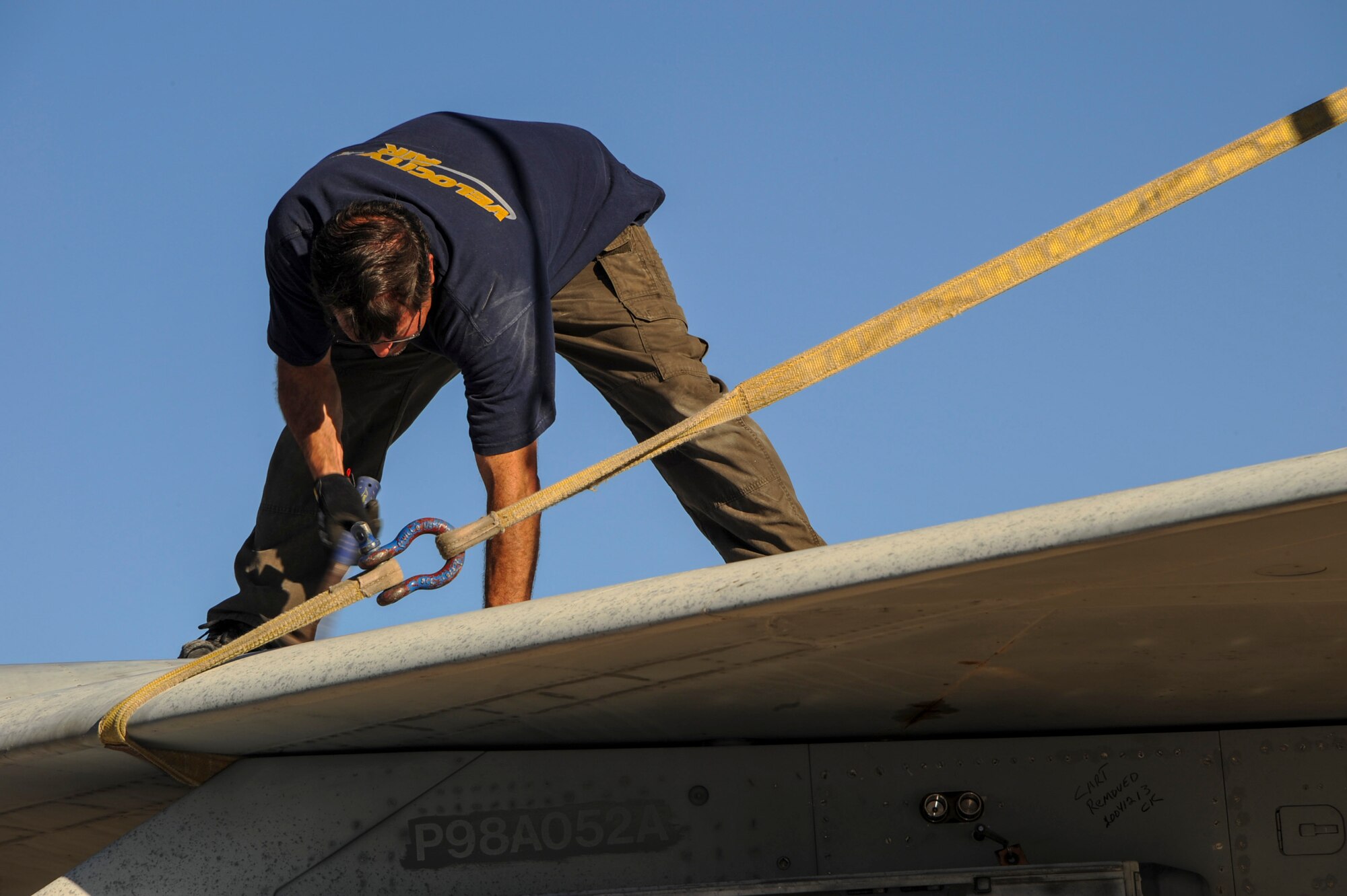 Tim Amalong, airframe mechanic, prepares to remove a wing from an F-15A Eagle on the flightline at Davis-Monthan Air Force Base, Ariz., Nov. 19, 2015. A team of contractors, including Amalong, took five days to completely disassemble the aircraft and load it onto two flatbed trucks to be shipped to Joint Base Lewis-McChord, Wash., for display. The entire project is estimated to take approximately eight months from the planning stage to finish. (U.S. Air Force photo by Airman Basic Nathan H. Barbour/Released)