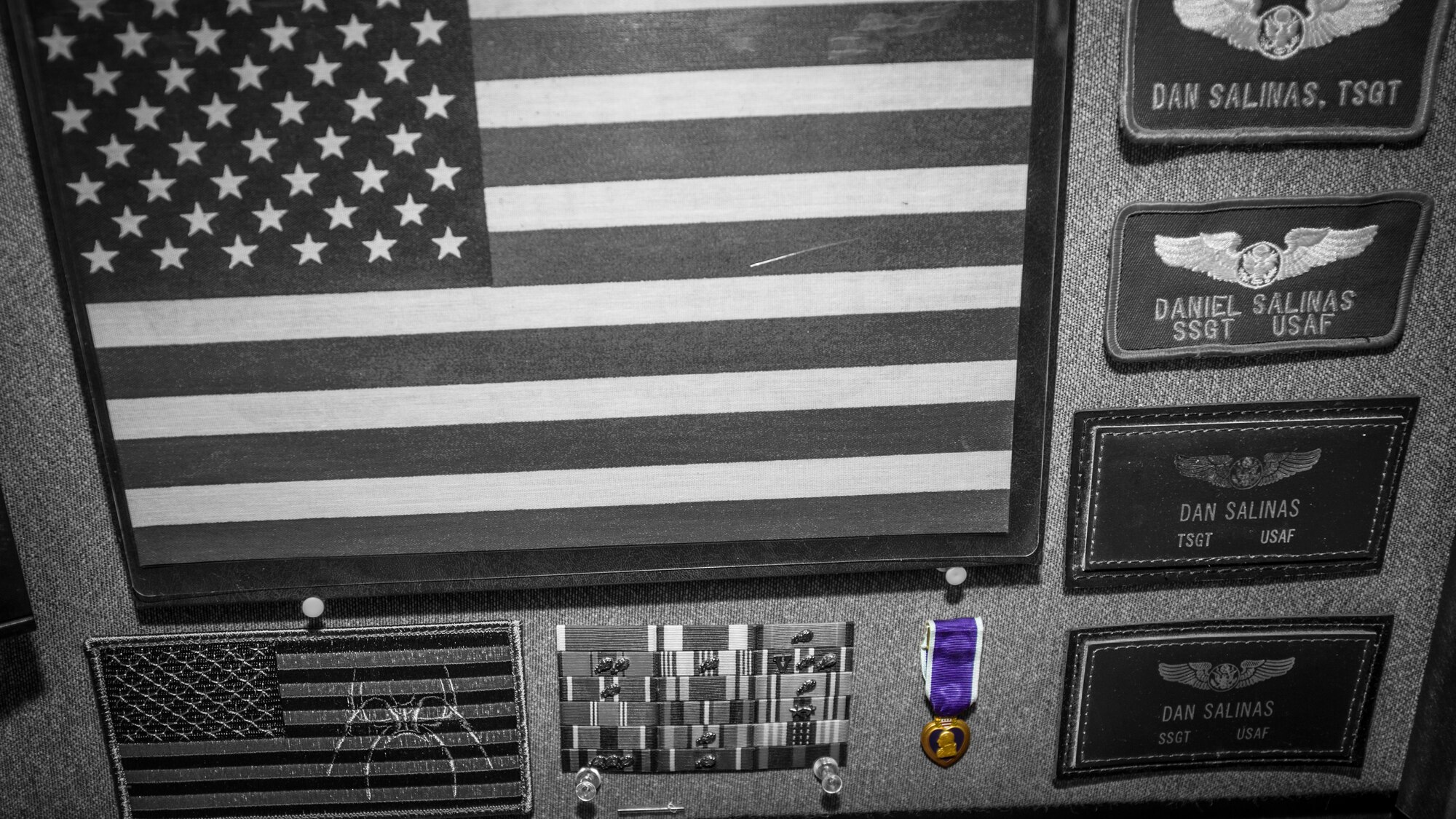 A purple heart is displayed on the desk of Daniel Salinas, a Khobar Towers bombing survivor, on Sept. 9 at Holloman Air Force Base, N.M.  The Khobar Towers, located near Dhahran, Saudi Arabia, were bombed June 25, 1996, killing 19 service members and wounding 372 more. Salinas, who was deployed as the staff sergeant of safety, was injured in the blast. Salinas currently works as the 49th Wing Occupational Safety Technician. (U.S. Air Force photo by Airman 1st Class Emily A. Kenney) 
