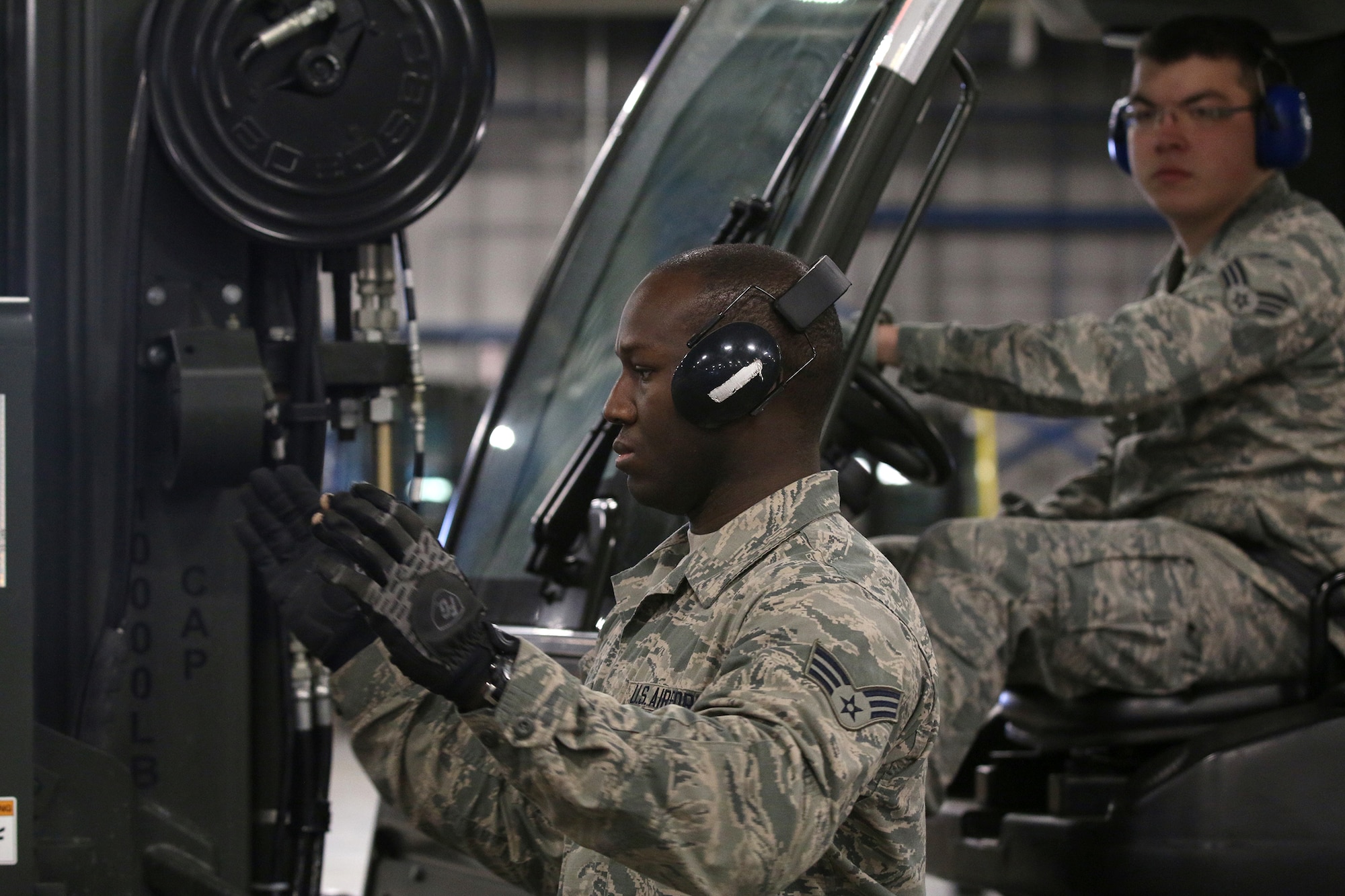 WRIGHT-PATTERSON AIR FORCE BASE, Ohio – Senior Airman Nicholas Giannuzzi, 87th Aerial Port Squadron cargo processor, drives the forklift while Senior Airman Dylan Lewis-Lee, 87th Aerial Port Squadron cargo processor, guides him during a cargo build-up portion of forklift training held during the Nov. 6, 2015 unit training assembly. (U.S. Air Force photo /Tech. Sgt. Patrick O’Reilly)