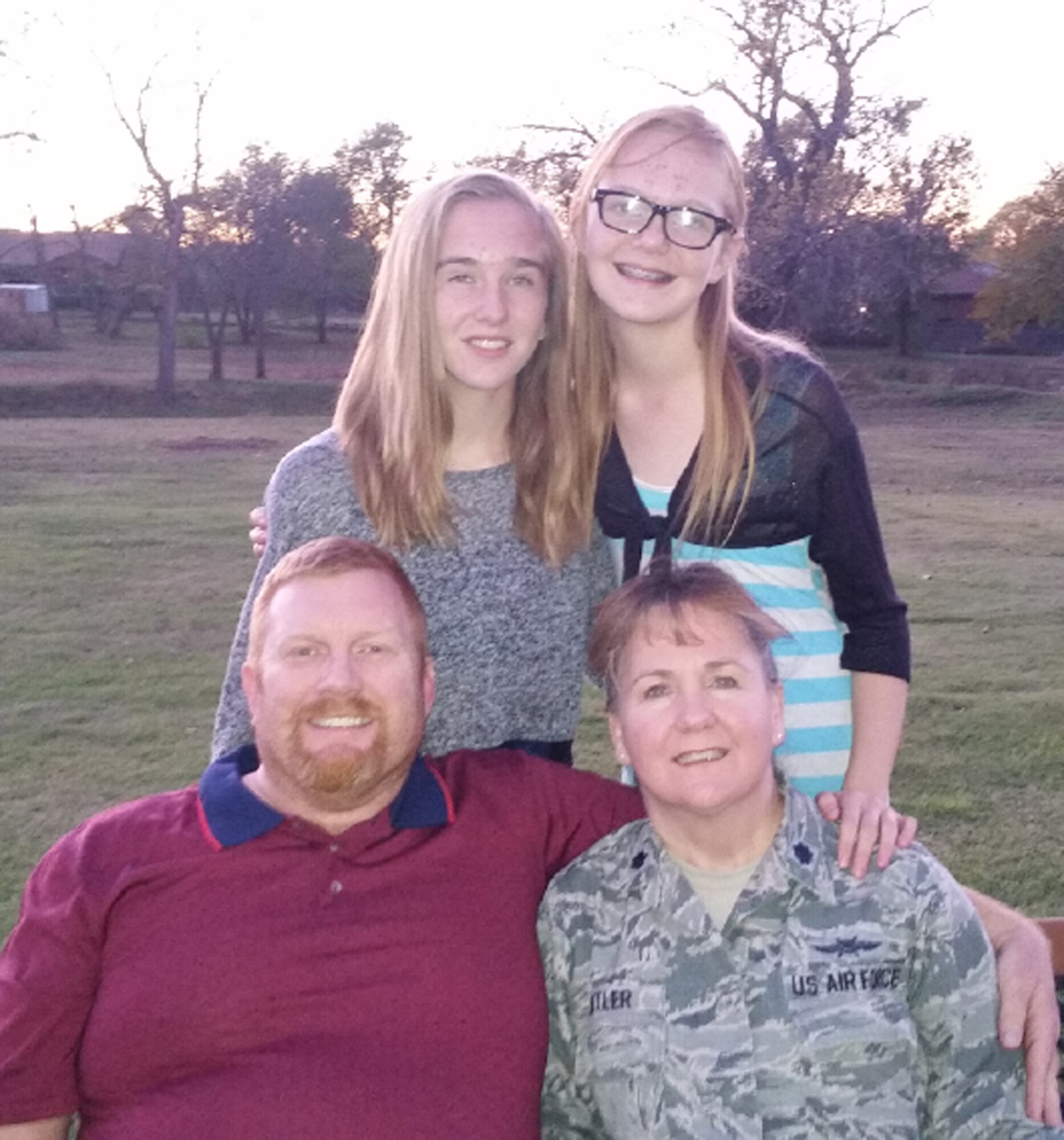 Lt. Col. Elizabeth Kettler (lower right) poses with her husband, Scott, and daughters, Connie (upper left) and Katie (upper right).