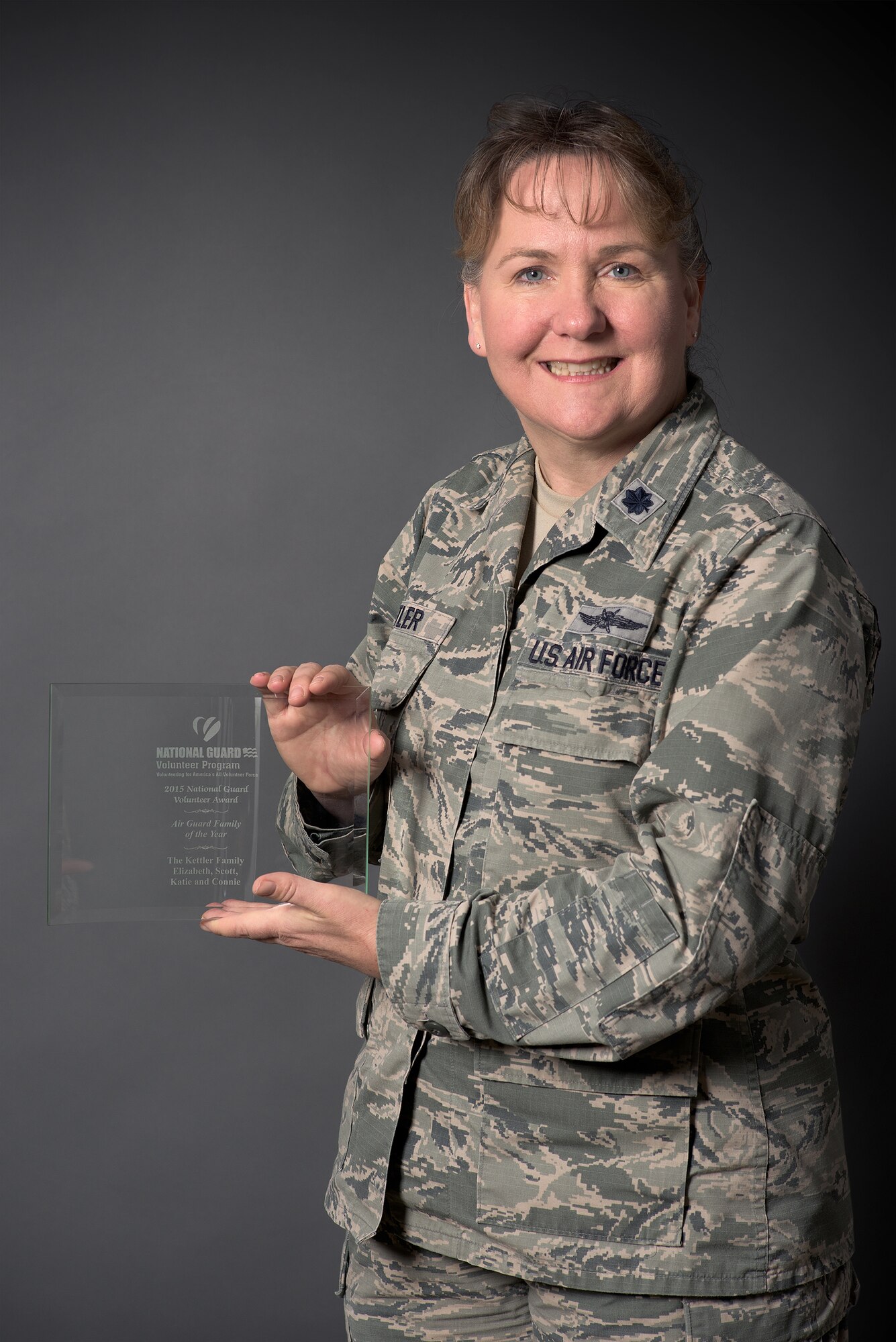 Lt. Col. Elizabeth Liz Kettler, 137th Air Refueling Wing Information Protection Chief, poses with the 2015 Air National Guard Family of the Year award. 