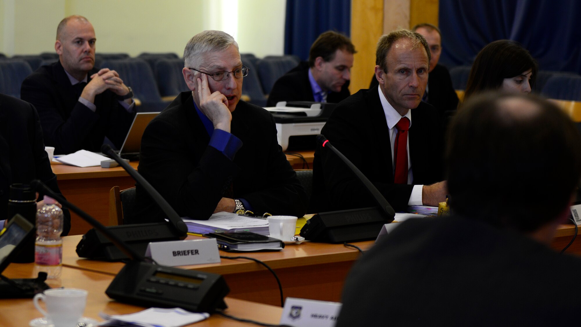(Middle) U.S. Air Force Brig. Gen. Mark Camerer, Strategic Airlift Capability Steering Board chairman, and Swedish Armed Forces Col. Olle Hultgren, NATO Airlift Management Programme Board chairman, speak to members of the combined Steering Board and Programme Board, Nov. 18, 2015, at Pápa Air Base, Hungary. Biannual meetings are held to bring the 12 member nations together to make decisions regarding the financial and operational aspects of the SAC Program. (U.S. Air Force photo by Senior Airman Areca T. Bell/Released)