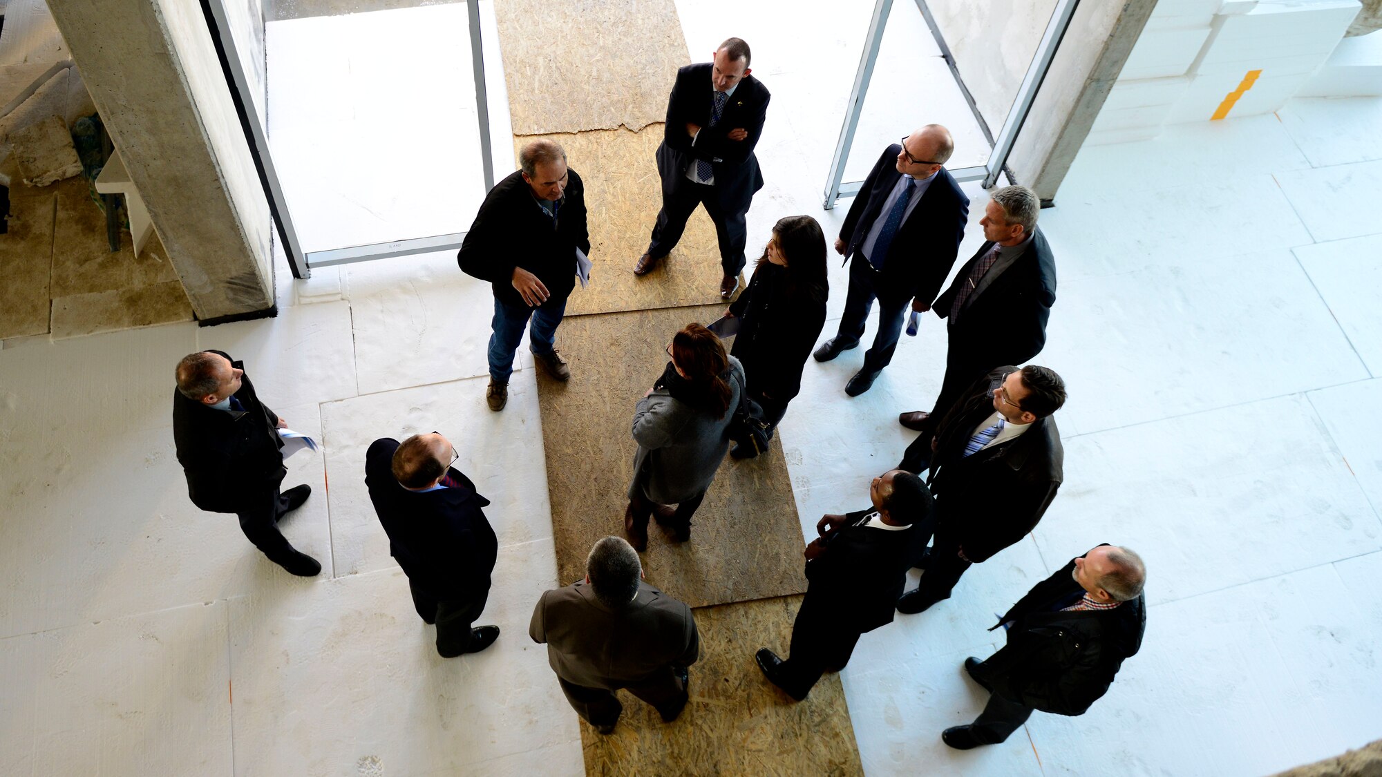 Members of the Strategic Airlift Capability Steering Board and NATO Airlift Management Programme Board tour facilities being constructed on Pápa Air Base, Hungary, Nov. 18, 2015. The members visited the hangar complex, which consists of a C-17 Globemaster III capable hangar, back shop maintenance, warehouse and office spaces, and also visited a new air traffic control tower. (U.S. Air Force photo by Senior Airman Areca T. Bell/Released)