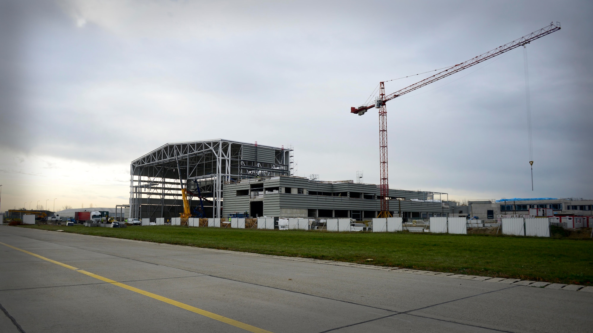 Members of the Strategic Airlift Capability Steering Board and NATO Airlift Management Programme Board tour facilities being constructed on Pápa Air Base, Hungary, Nov. 18, 2015. The members visited the hangar complex, which consists of a C-17 Globemaster III capable hangar, back shop maintenance, warehouse and office spaces, and also visited a new air traffic control tower. (U.S. Air Force photo by Senior Airman Areca T. Bell/Released)