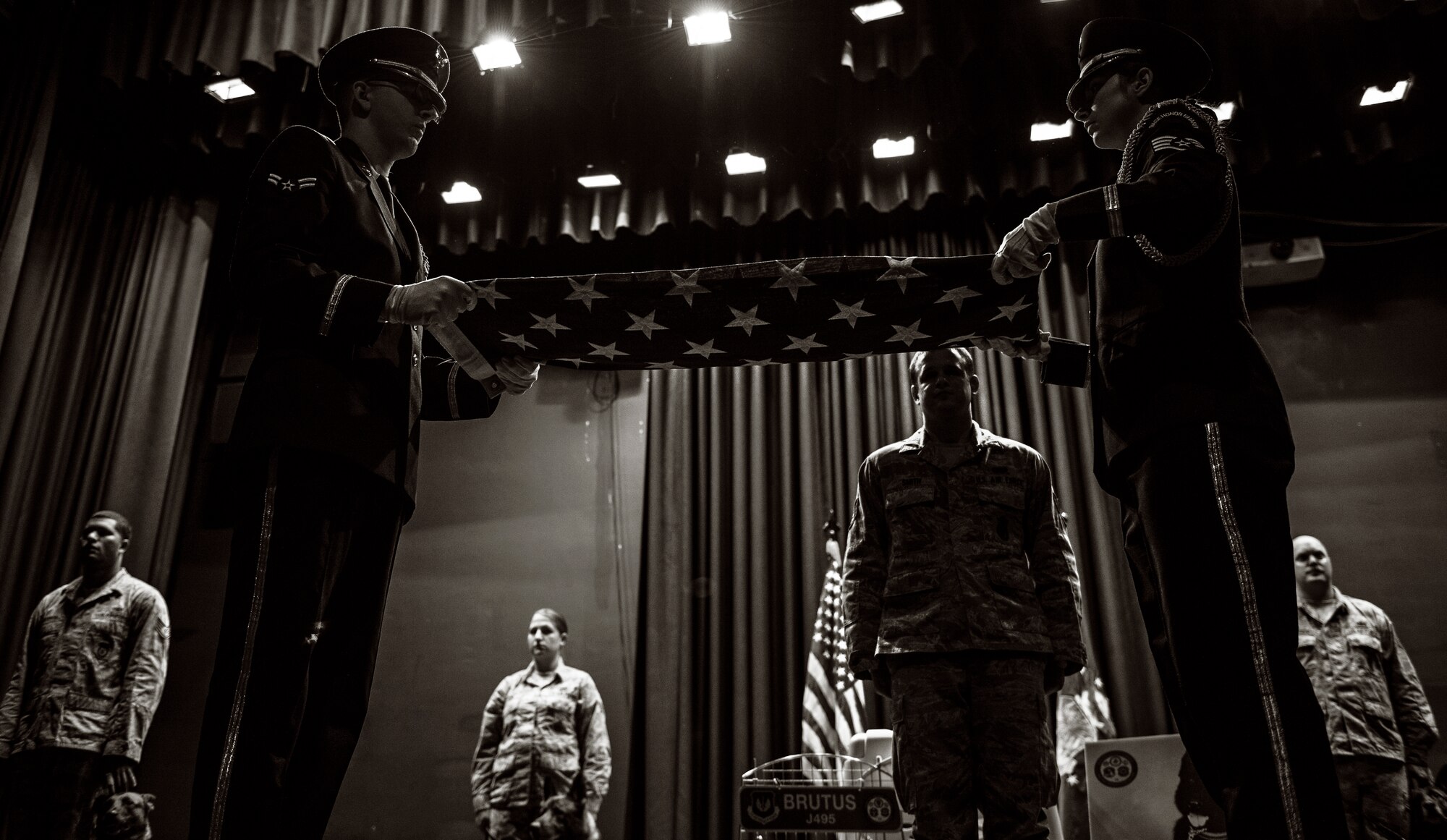 Staff Sgt. Michael Smith, 86th Security Forces Squadron military working dog handler, watches as an American flag is folded during a memorial service in honor of his MWD, Brutus Nov. 20, 2015 at Ramstein Air Base, Germany. Brutus served with the 86th SFS as a patrol explosive detection dog for 13 years. (U.S. Air Force photo/Staff Sgt. Sara Keller)