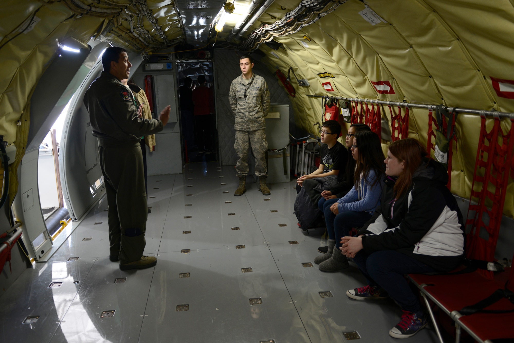 Students listen as aircrew and maintenance Airmen talk about how they use STEM principles while flying or maintaining aircraft, Nov. 12, 2015, McConnell Air Force Base, Kan. More than 150 students from local schools visited McConnell to learn about how Airmen apply the pillars of STEM to their daily mission. (U.S. Air Force photo/Senior Airman Trevor Rhynes)