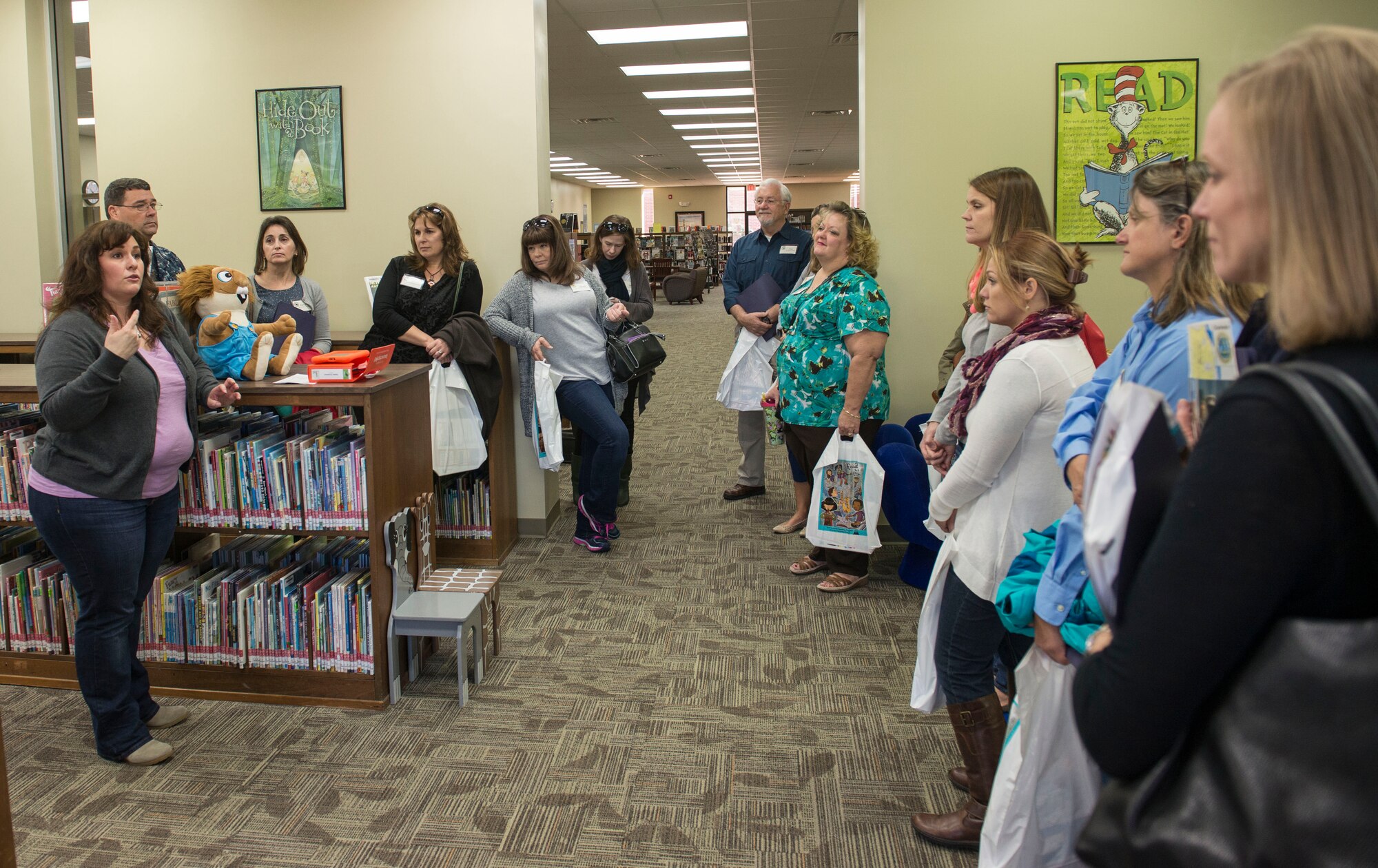 During a tour by the JB Charleston senior leadership spouses on JB Charleston – NWS, S.C., on Nov. 20, 2015, Angela Aschenbrenner, Joint Base Charleston library director, explains how both libraries on the Air Base and the Naval Weapons Station function.. The spouses learned the 2013 renovation of the library on the NWS was its first since the 1960’s. (U.S. Air Force photo/Airman 1st Class Thomas T. Charlton)