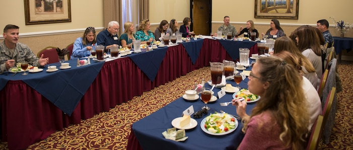 Chief Master Sgt. Mark Bronson, 628th ABW command chief, Col. Robert Lyman, 628th Air Base Wing commander and Cmdr. David Tarwater, Joint Base Charleston Naval Support Activity executive officer, have lunch with the JB Charleston spouses at the Red Bank Club at JB Charleston – NWS, S.C., on Nov. 20, 2015. The spouses were participating in the tour to get a different perspective of JB Charleston and be able to provide constructive feedback about possible improvements. (U.S. Air Force photo/Airman 1st Class Thomas T. Charlton)