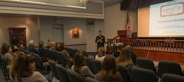 Navy Captain Kevin Byrne, Navy Nuclear Power Training Command commanding officer, briefs the Joint Base Charleston senior leadership spouses about the programs and courses provided at the NNPTC  at JB Charleston – NWS, S.C., on Nov. 20, 2015. (U.S. Air Force photo/Airman 1st Class Thomas T. Charlton)