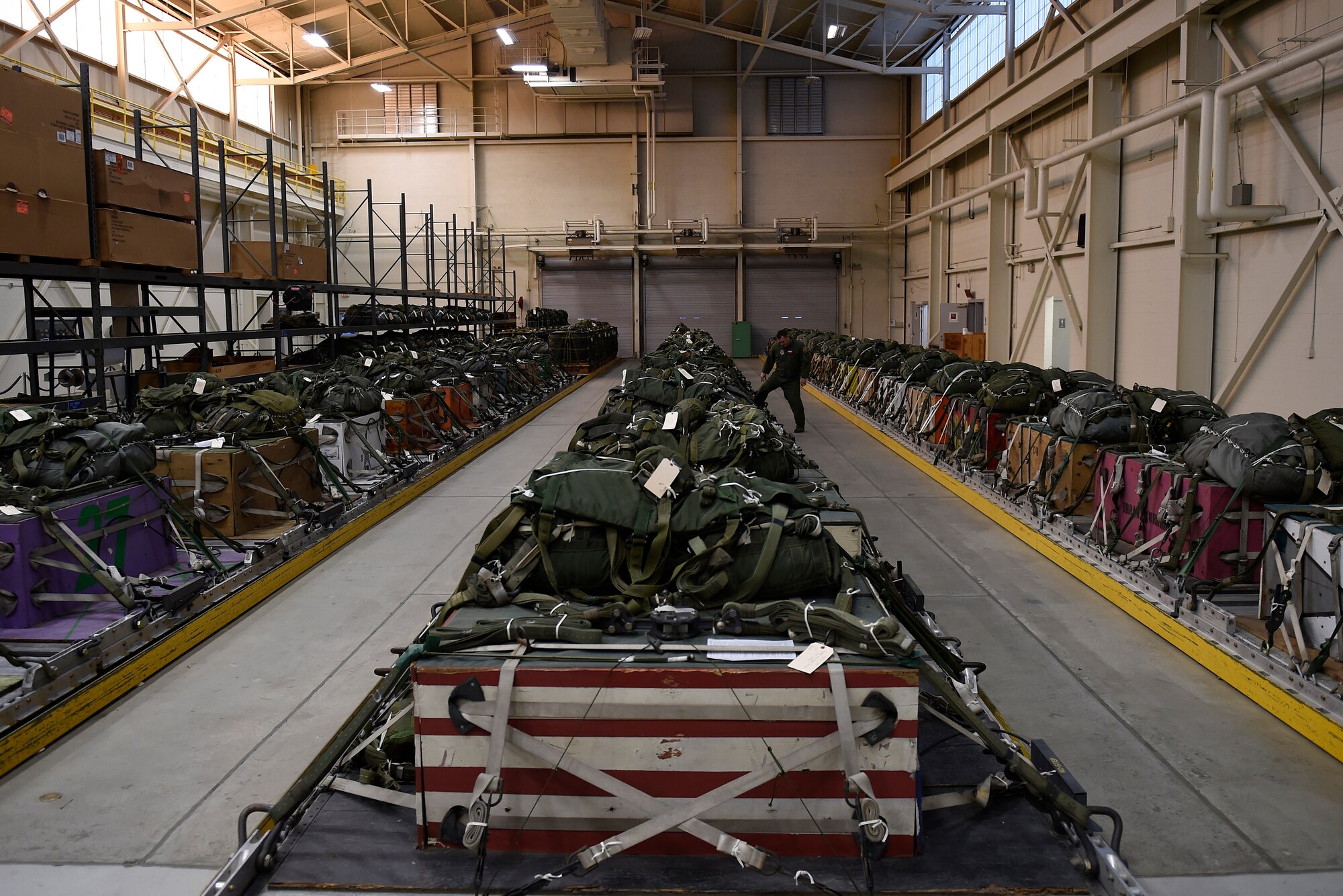Tech Sgt. Robert Weinbrecht, 62nd Operations Support Squadron joint airdrop inspector, inspects air drop bundles Oct. 21, 2015, at Joint Base Lewis-McChord, Wash. During Wienbrecht’s time in the Joint inspections office there has not been one malfunction due to human error. (U.S. Air Force photo by Staff Sgt. Tim Chacon)