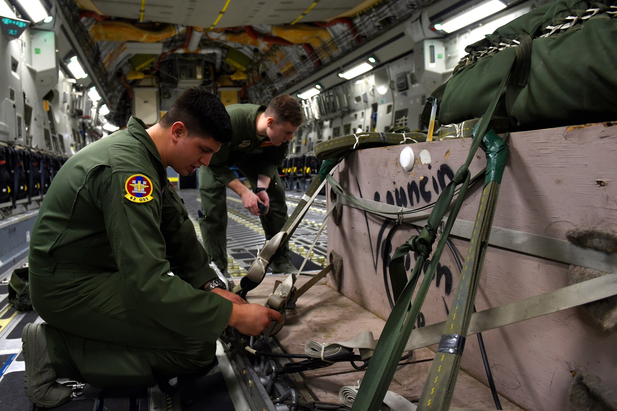 Staff Sgt. Eric Bailey (left), 62nd Operations Support Squadron joint airdrop inspector, inspects an air drop bundle Oct. 21, 2015, at Joint Base Lewis-McChord, Wash. The Joint Airdrop Inspection office has conducted more than 730 inspections in 2015. (U.S. Air Force photo by Staff Sgt. Tim Chacon)