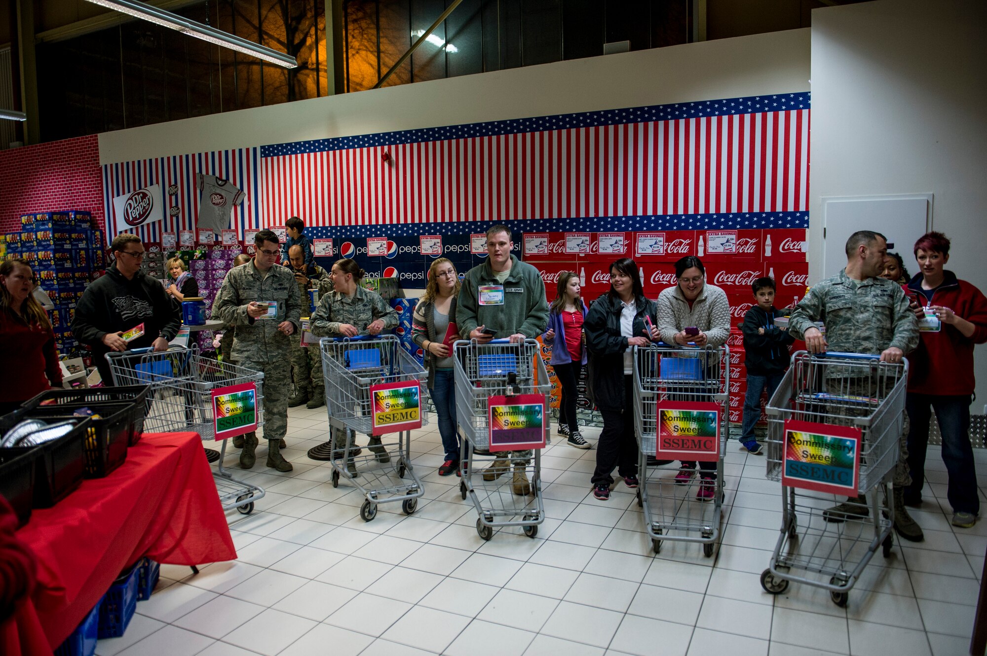 Contestants get ready to start shopping during the 2015 Commissary Sweep at Spangdahlem Air Base, Germany, Nov. 23, 2015. The participants were chosen during the deployed family member Thanksgiving dinner from five different categories which are unaccompanied Airman, accompanied Airman, accompanied Airman with one-two kids, accompanied Airman with three or more and Spangdahlem Spouses Enlisted Members Club. (U.S. Air Force photo by Senior Airman Rusty Frank/Released)