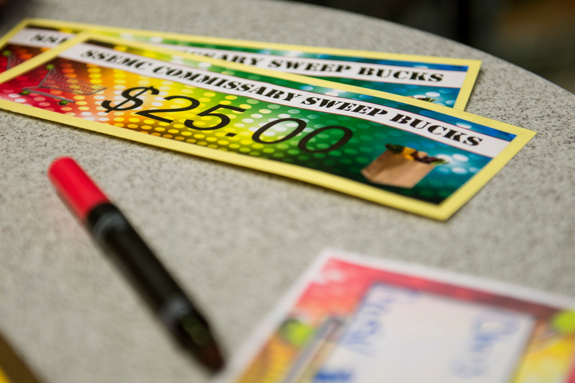 Commissary Sweep bucks lie on a table during the 2015 Commissary Sweep at Spangdahlem Air Base, Germany, Nov. 23, 2015. Contestants of the competition used the money to pay for groceries during the third round of the event. (U.S. Air Force photo by Senior Airman Rusty Frank/Released)
