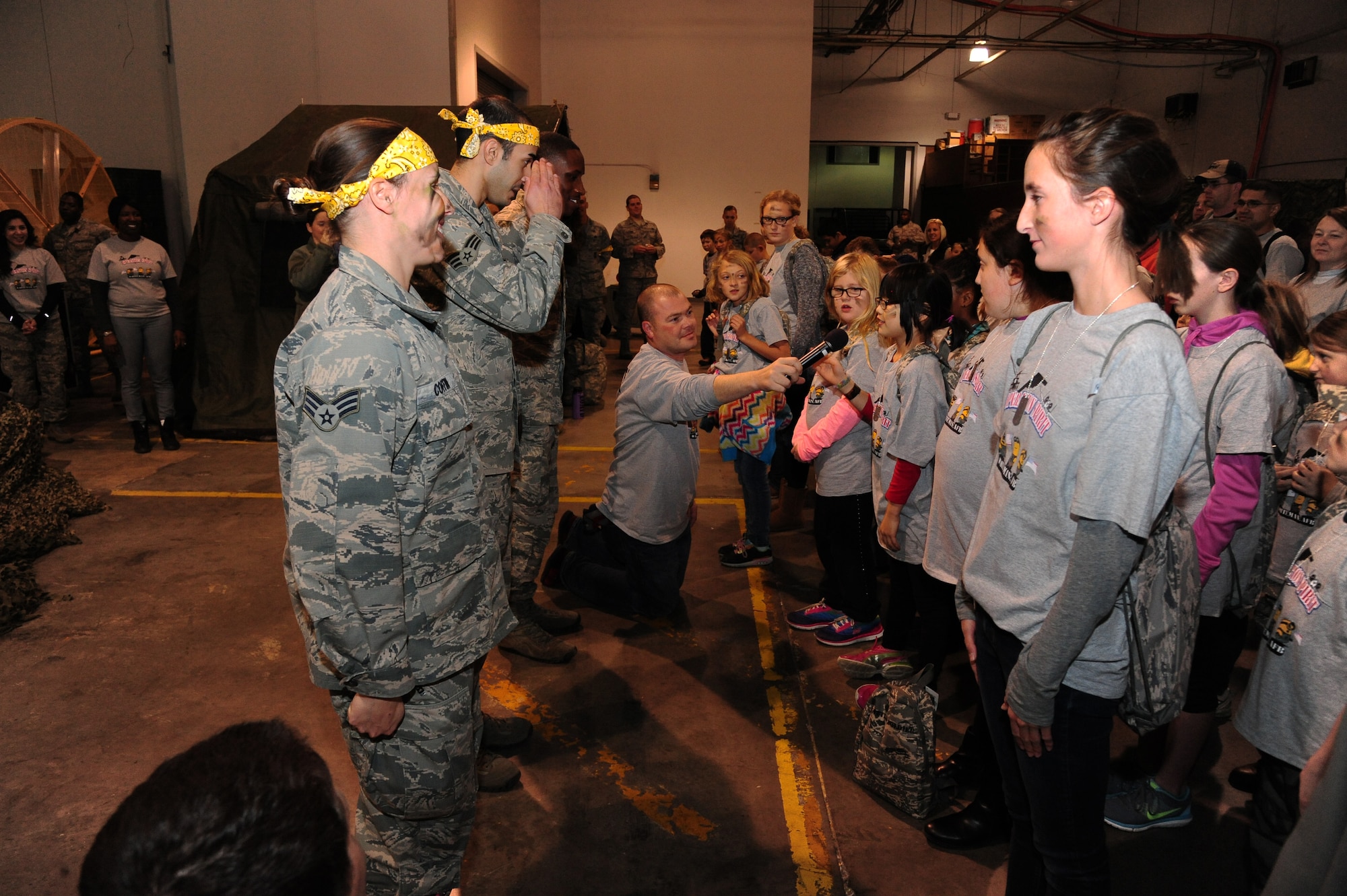 Children report to their respective group leaders during Operation Spirit at Whiteman Air Force Base, Mo., Nov. 21, 2015. The children were divided into seven different groups to learn about various aspects of the deployement process to include combative training, survival tactics and communication operations. (U.S. Air Force photo by Senior Airman Keenan Berry) 