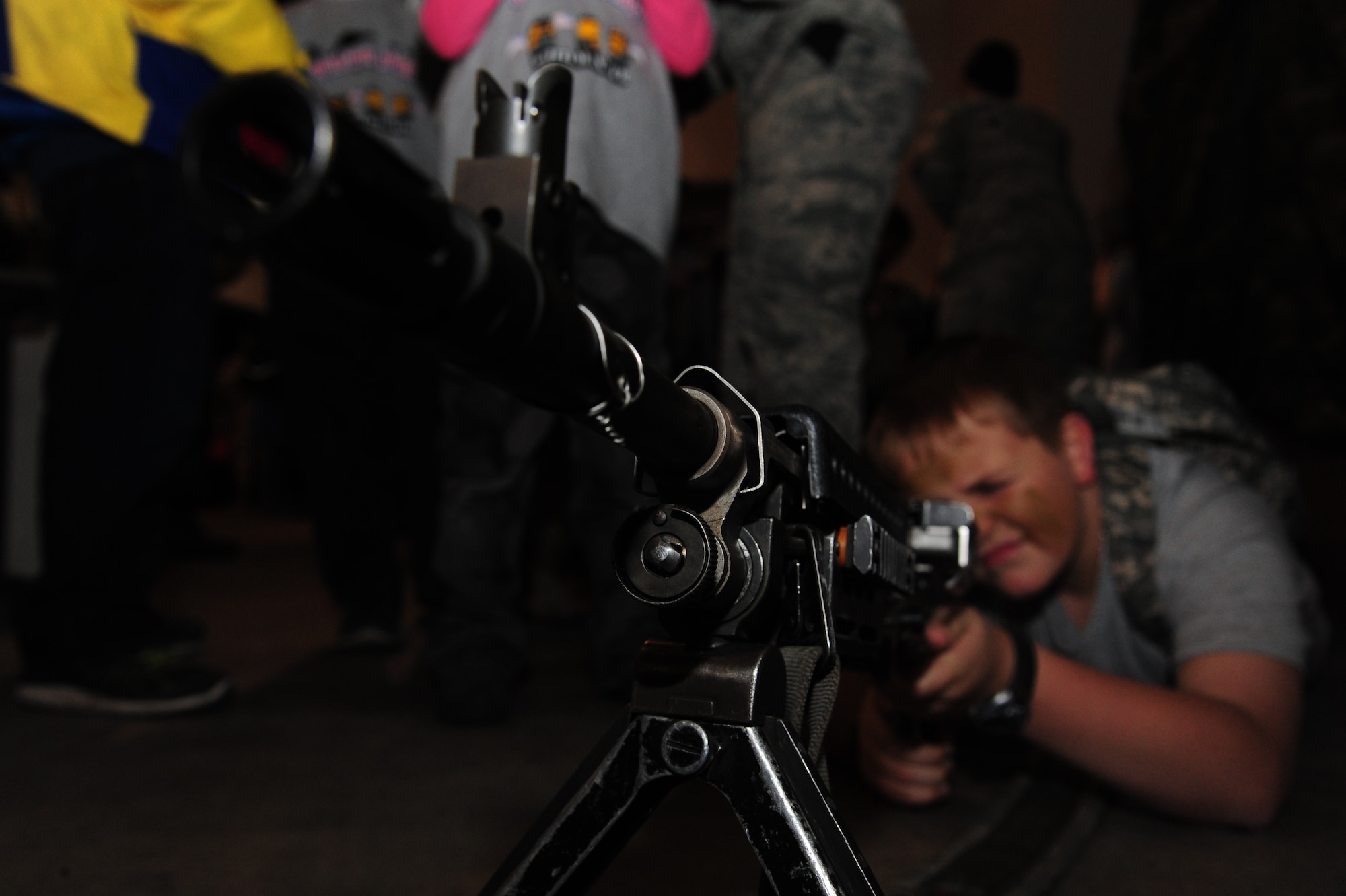 Jack Connolly, son of U.S. Air Force Lt. Col. Paul Connolly from the 509th Bomb Wing judicial affairs, aims an M240 Bravo during Operation Spirit at Whiteman Air Force Base, Mo., Nov. 21, 2015. Operation Spirit is designed to assist families in building resiliency, educating children about deployments and lessening fears during the process. (U.S. Air Force photo by Senior Airman Keenan Berry)