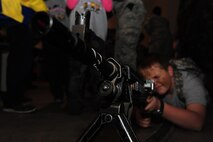 Jack Connolly, son of U.S. Air Force Lt. Col. Paul Connolly from the 509th Bomb Wing judicial affairs, aims an M240 Bravo during Operation Spirit at Whiteman Air Force Base, Mo., Nov. 21, 2015. Operation Spirit is designed to assist families in building resiliency, educating children about deployments and lessening fears during the process. (U.S. Air Force photo by Senior Airman Keenan Berry)