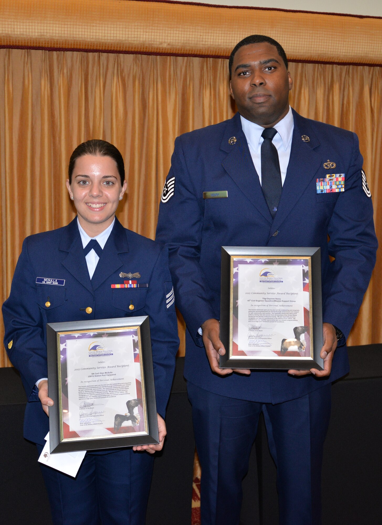 Seaman Carli Gian McSulla of the Coast Guard, (left) Tech. Sgt. Dayrone Henry, 45th Civil Engineer Squadron, and Tamara Acfalle, 45th Force Support Squadron, (not pictured), were recipients of the Military Affairs Council Community Service Award in Cocoa Beach, Fla., Nov. 18, 2015.  Each received an award for their time donated to the community through organizations. The winners were selected by a panel of Chamber of Commerce members based on the strength of their commitment to the local community. (U.S. Air Force photo/1st Lt. Alicia Premo/Released) 