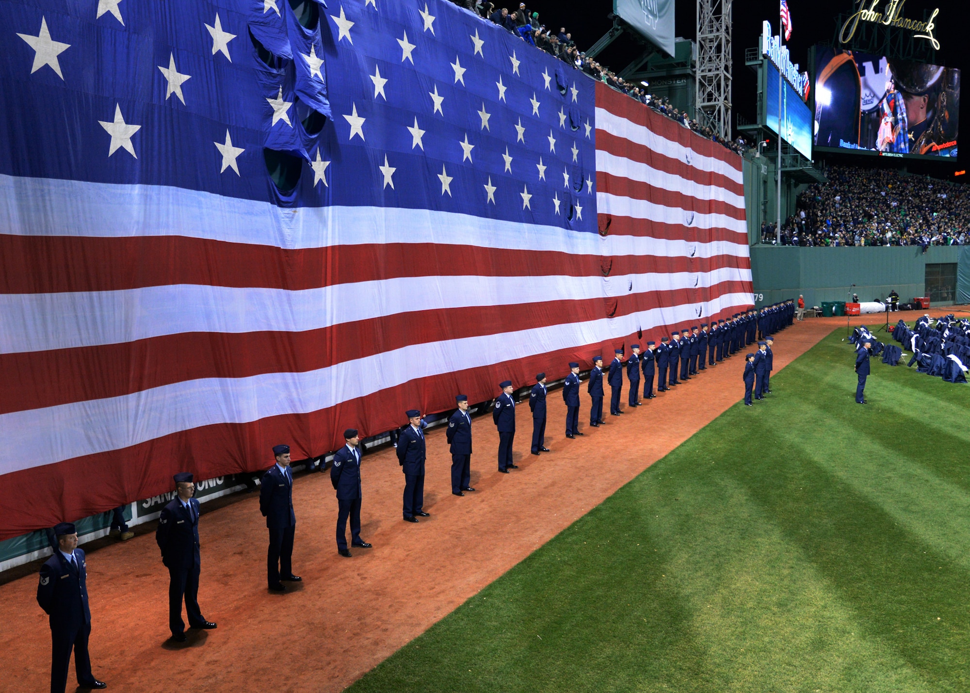 Airmen from Hanscom Air Force Base, Mass., participate in pregame festivities at Fenway Park in Boston during a college football game between Boston College and the University of Notre Dame Nov. 21. After the national anthem was performed, the Airmen gathered the American flag and carried it off the field. (U.S. Air Force photo by Mark Herlihy)