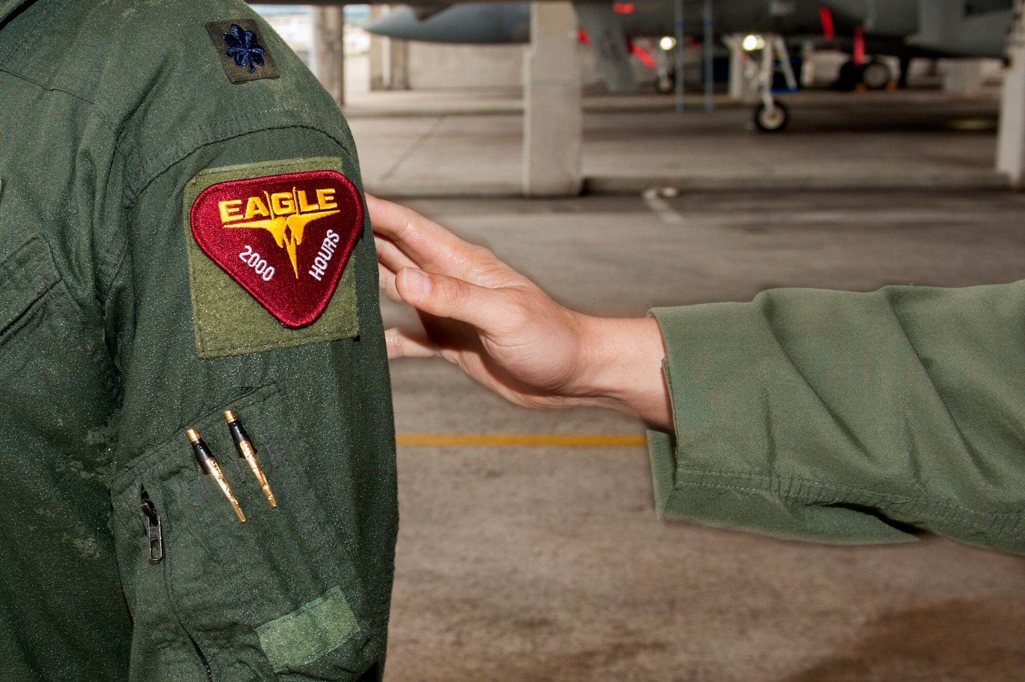 U.S. Air Force Lt. Col. Alexander Haddad, 44th Fighter Squadron pilot, receives a 2,000 flying hour patch from Lt. Col. Kevin Jamieson, 44th FS commander, Nov. 19, 2015, at Kadena Air Base, Japan. Reaching 2,000 flying hours as an F-15 Eagle pilot is a rare occurrence because routine training flights usually last around 45 minutes to an hour. (U.S. Air Force photo by Airman 1st Class Corey M. Pettis)