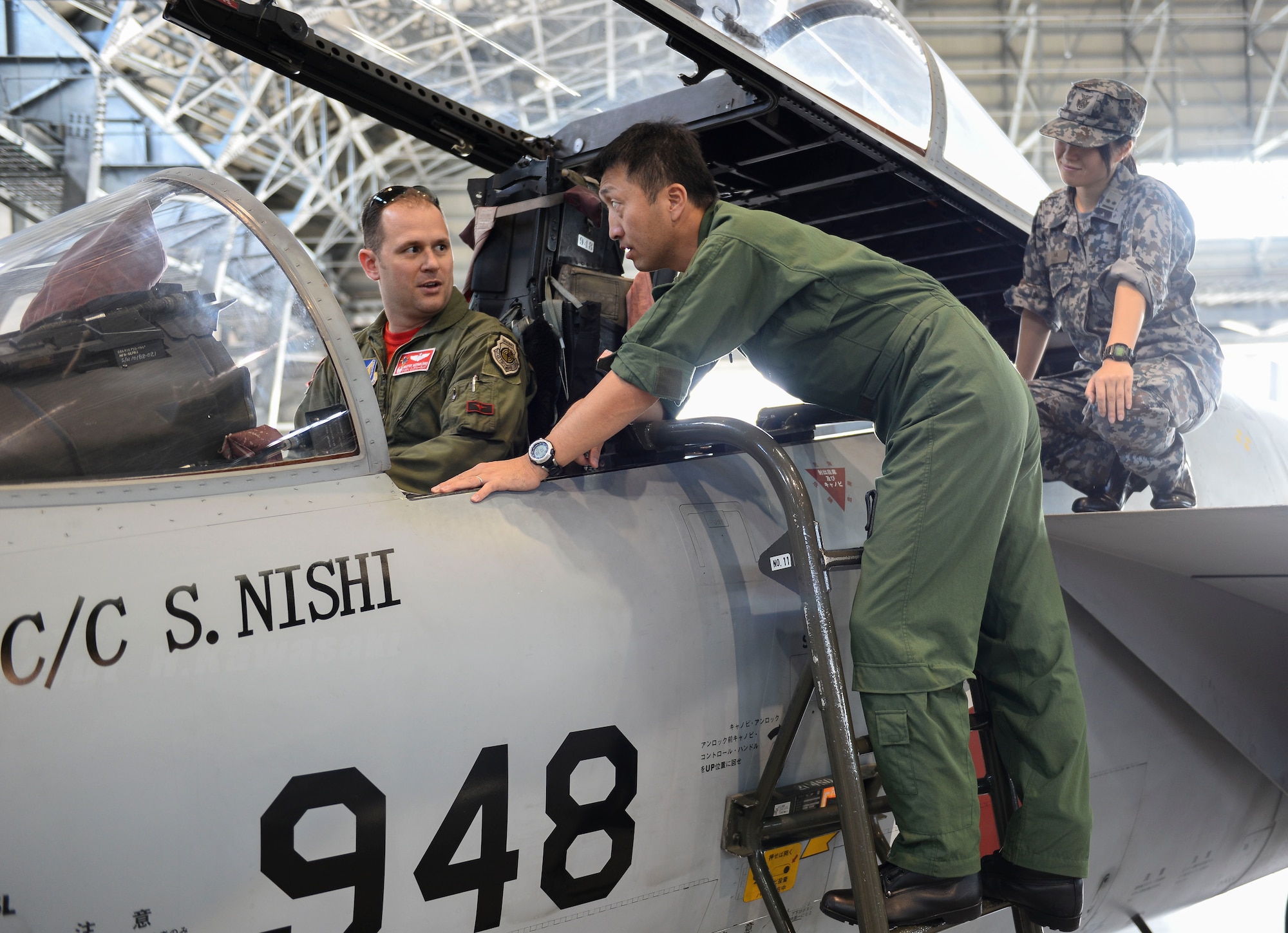 U.S. Air Force Lt. Col. Chris McFarland, 67th Fighter Squadron commander, peruses the cockpit of a Japan Air Self-Defense Force F-15 Eagle during a wing exchange tour Nov. 20, 2015, at Naha Air Base, Japan. The tour provided U.S. Airmen the opportunity to understand the role of Naha AB and interact with their counterparts from similar career fields. (U.S. Air Force photo by Senior Airman John Linzmeier)  