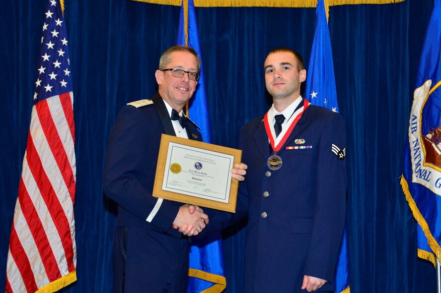 MCGHEE TYSON AIR NATIONAL GUARD BASE, Tenn. - Senior Airman Ross Koba, right, receives the Distinguished Graduate Award for Airman leadership school class 16-1 from Major General Daryl Bohac, adjutant general of the Nebraska National Guard, here, Nov. 19, 2015, at the I. G. Brown Training and Education Center. The distinguished graduate award is presented to students in the top 10 percent of the class. (U.S. Air National Guard photo by Master Sgt. Jerry D. Harlan/Released)