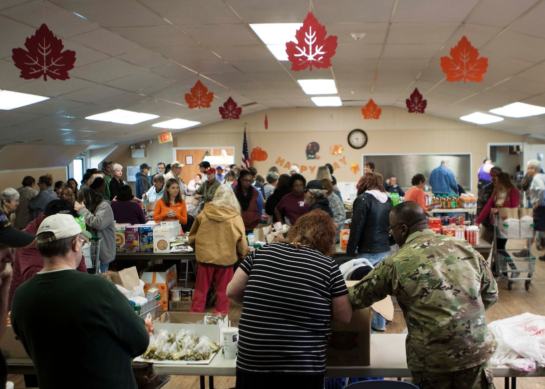 Army Brig. Gen. Richard Dix, commander, DLA Distribution helps distribute Thanksgiving meals to the local community at the West Shore Senior Center on Nov. 20. 

