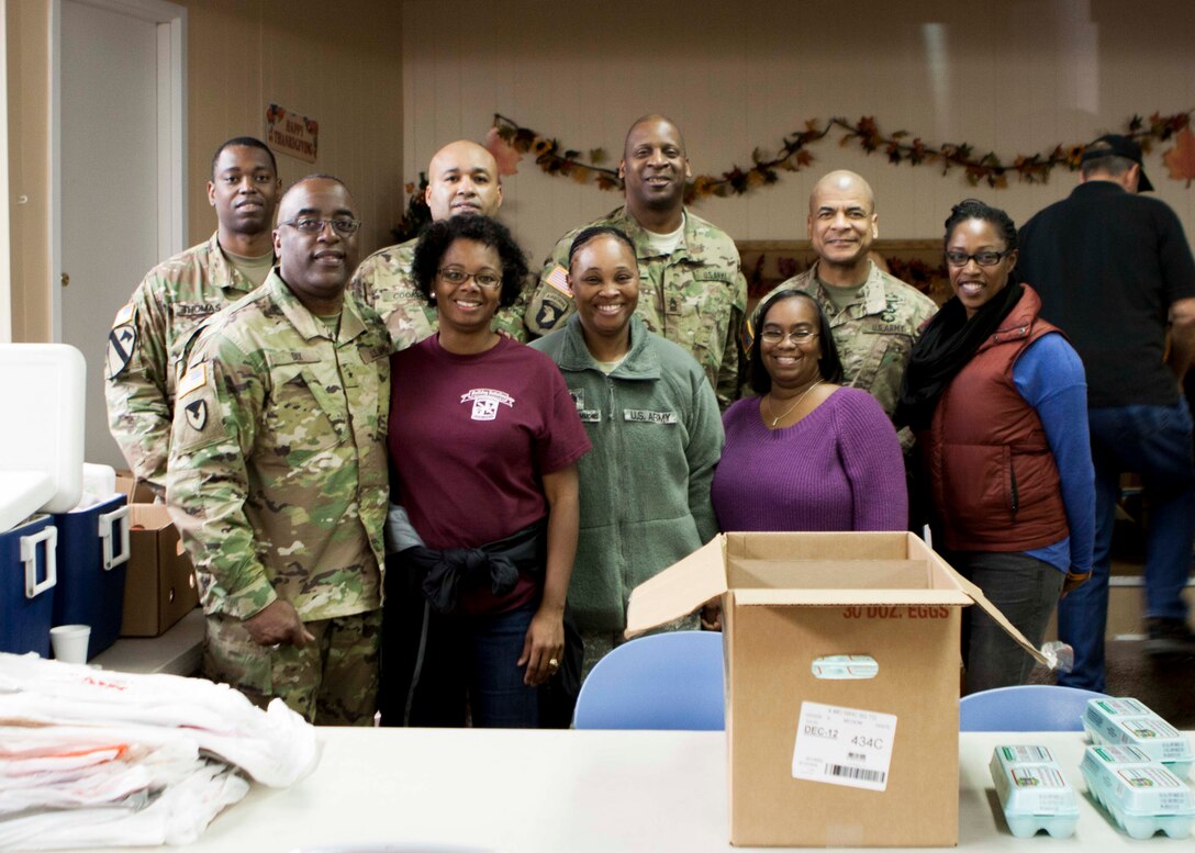 Army Brig. Gen. Richard Dix, commander, DLA Distribution (front row, left), and other military members and their spouses stationed at Defense Distribution Center, Susquehanna, volunteered their time on Nov. 20 to help distribute Thanksgiving meals to those in need at the West Shore Senior Center.